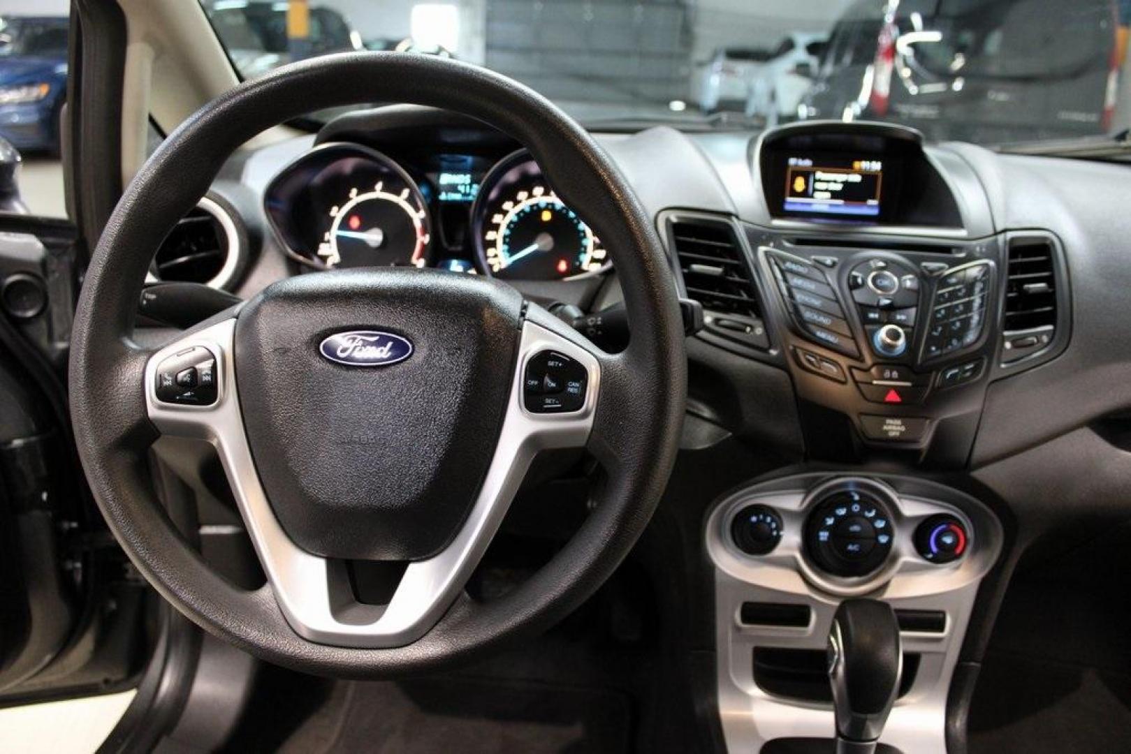 2019 Magnetic /Black Ford Fiesta SE (3FADP4EJ7KM) with an 1.6L I4 Ti-VCT engine, Automatic transmission, located at 15300 Midway Rd., Addison, TX, 75001, (972) 702-0011, 32.958321, -96.838074 - HOME OF THE NO HAGGLE PRICE - WHOLESALE PRICES TO THE PUBLIC!!<br><br>Magnetic 2019 Ford Fiesta SE<br><br>Recent Arrival! 27/37 City/Highway MPG<br><br><br>At Midway Auto Group, we strive to provide you with the best quality vehicles for the lowest possible price, and this 2019 Ford Fiesta is no exc - Photo#16