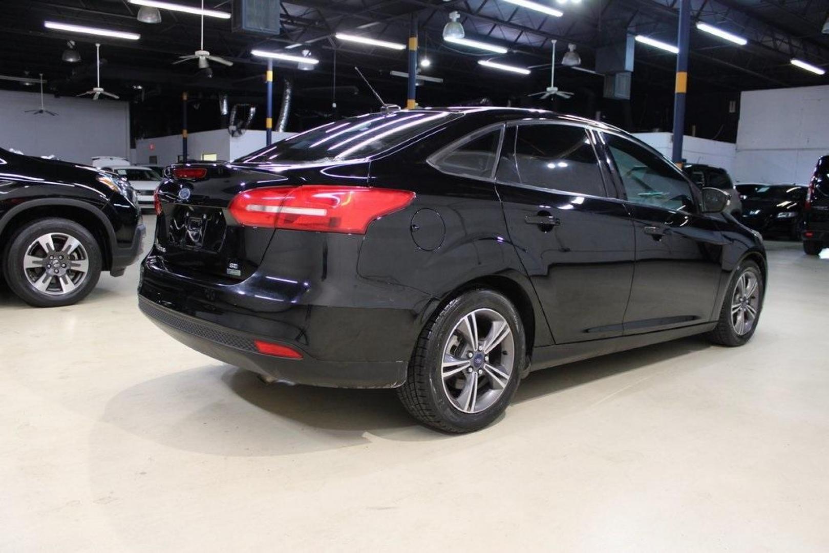 2017 Shadow Black /Charcoal Black Ford Focus SE (1FADP3FE8HL) with an EcoBoost 1.0L I3 GTDi DOHC Turbocharged VCT engine, Automatic transmission, located at 15300 Midway Rd., Addison, TX, 75001, (972) 702-0011, 32.958321, -96.838074 - HOME OF THE NO HAGGLE PRICE - WHOLESALE PRICES TO THE PUBLIC!!<br><br>Shadow Black 2017 Ford Focus SE<br><br>Recent Arrival! 27/38 City/Highway MPG<br><br>Awards:<br> * 2017 KBB.com 10 Most Awarded Brands * 2017 KBB.com Brand Image Awards<br><br>At Midway Auto Group, we strive to provide you with - Photo#2