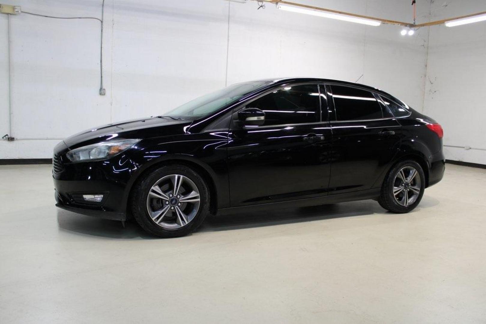 2017 Shadow Black /Charcoal Black Ford Focus SE (1FADP3FE8HL) with an EcoBoost 1.0L I3 GTDi DOHC Turbocharged VCT engine, Automatic transmission, located at 15300 Midway Rd., Addison, TX, 75001, (972) 702-0011, 32.958321, -96.838074 - HOME OF THE NO HAGGLE PRICE - WHOLESALE PRICES TO THE PUBLIC!!<br><br>Shadow Black 2017 Ford Focus SE<br><br>Recent Arrival! 27/38 City/Highway MPG<br><br>Awards:<br> * 2017 KBB.com 10 Most Awarded Brands * 2017 KBB.com Brand Image Awards<br><br>At Midway Auto Group, we strive to provide you with - Photo#4