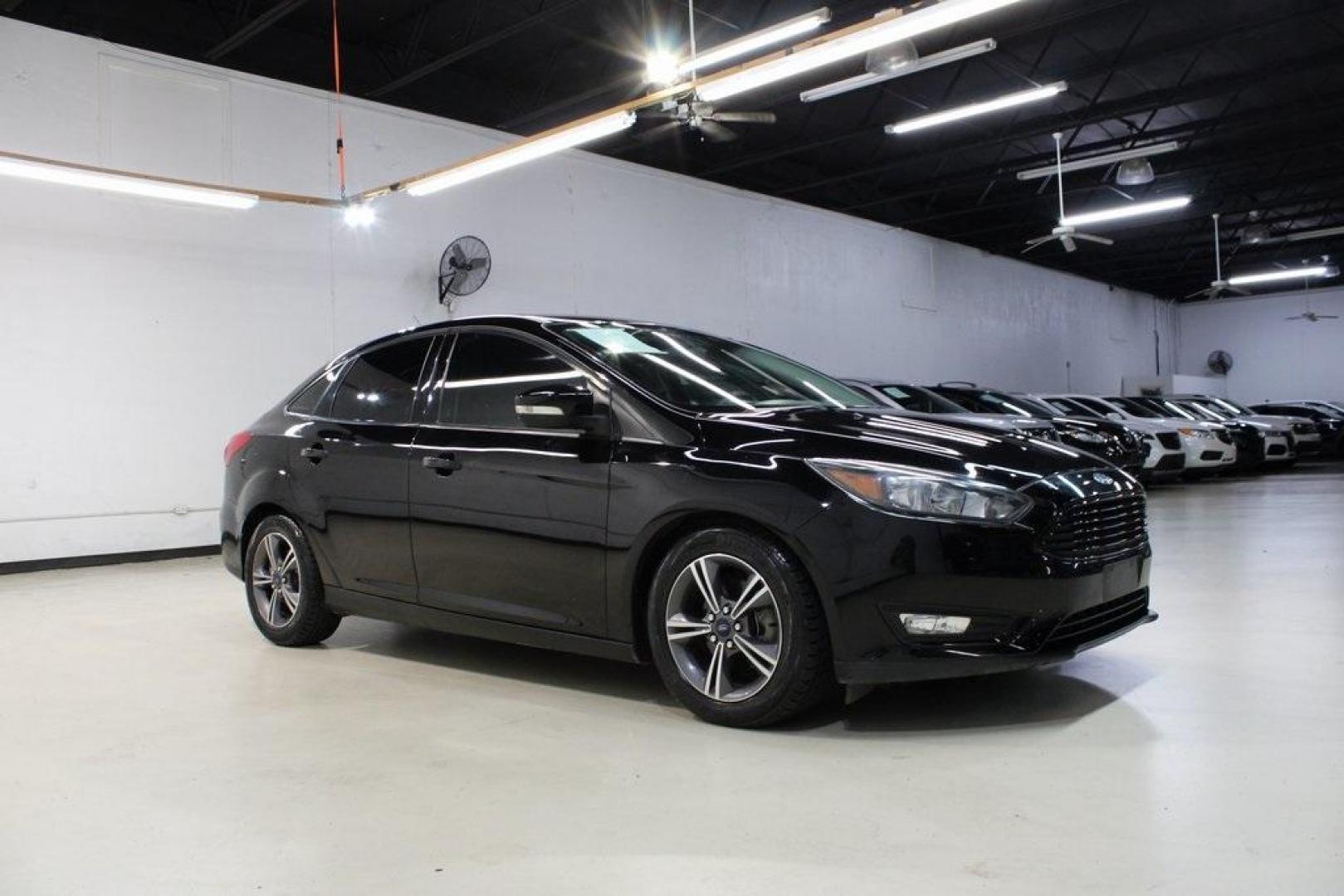 2017 Shadow Black /Charcoal Black Ford Focus SE (1FADP3FE8HL) with an EcoBoost 1.0L I3 GTDi DOHC Turbocharged VCT engine, Automatic transmission, located at 15300 Midway Rd., Addison, TX, 75001, (972) 702-0011, 32.958321, -96.838074 - HOME OF THE NO HAGGLE PRICE - WHOLESALE PRICES TO THE PUBLIC!!<br><br>Shadow Black 2017 Ford Focus SE<br><br>Recent Arrival! 27/38 City/Highway MPG<br><br>Awards:<br> * 2017 KBB.com 10 Most Awarded Brands * 2017 KBB.com Brand Image Awards<br><br>At Midway Auto Group, we strive to provide you with - Photo#6