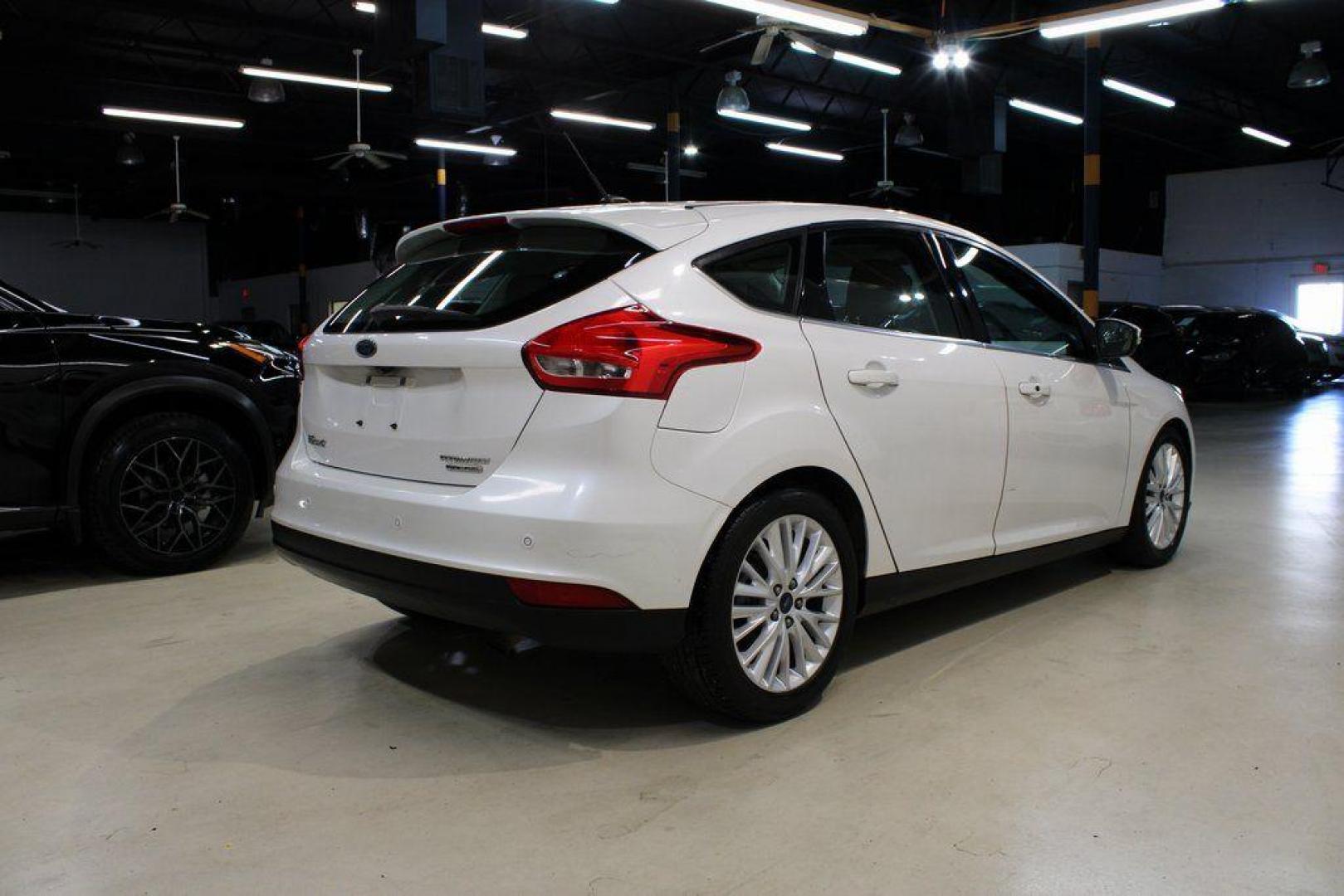 2016 White Platinum Clearcoat Metallic /Medium Soft Ceramic Ford Focus Titanium (1FADP3N2XGL) with an 2.0L I4 DGI Flex Fuel Ti-VCT engine, Automatic transmission, located at 15300 Midway Rd., Addison, TX, 75001, (972) 702-0011, 32.958321, -96.838074 - 2016 Ford Focus SE<br><br>Now Available at Midway Auto Group Addison, Texas<br><br>Efficient, comfortable, and versatilethe 2016 Ford Focus SE offers a great blend of fuel economy, modern technology, and everyday practicality. Whether you're commuting across DFW or looking for a reliable compact ca - Photo#1