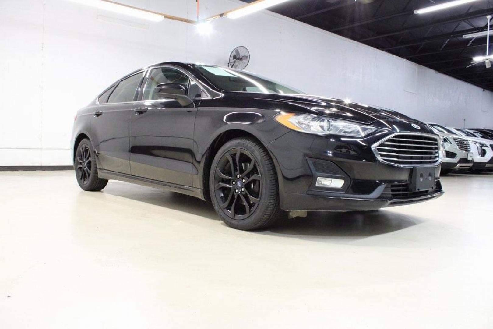 2019 Black /Light Putty Ford Fusion SE (3FA6P0HD1KR) with an 1.5L EcoBoost engine, Automatic transmission, located at 15300 Midway Rd., Addison, TX, 75001, (972) 702-0011, 32.958321, -96.838074 - Photo#1