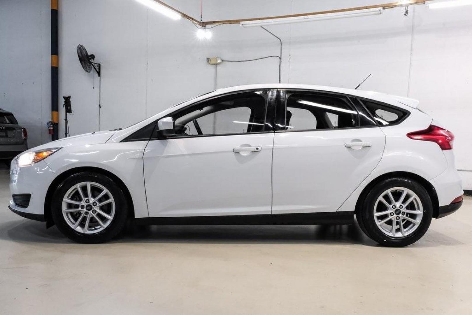 2018 Oxford White /Black Ford Focus SE (1FADP3K23JL) with an 2.0L I4 DGI Ti-VCT engine, Automatic transmission, located at 15300 Midway Rd., Addison, TX, 75001, (972) 702-0011, 32.958321, -96.838074 - 2018 Ford Focus SE<br><br>Now Available at Midway Auto Group, Addison, Texas<br><br>Efficient, comfortable, and great for everyday driving the 2018 Ford Focus SE delivers excellent fuel economy, modern technology, and a smooth, enjoyable ride. Whether you're commuting across DFW, shopping for a firs - Photo#9