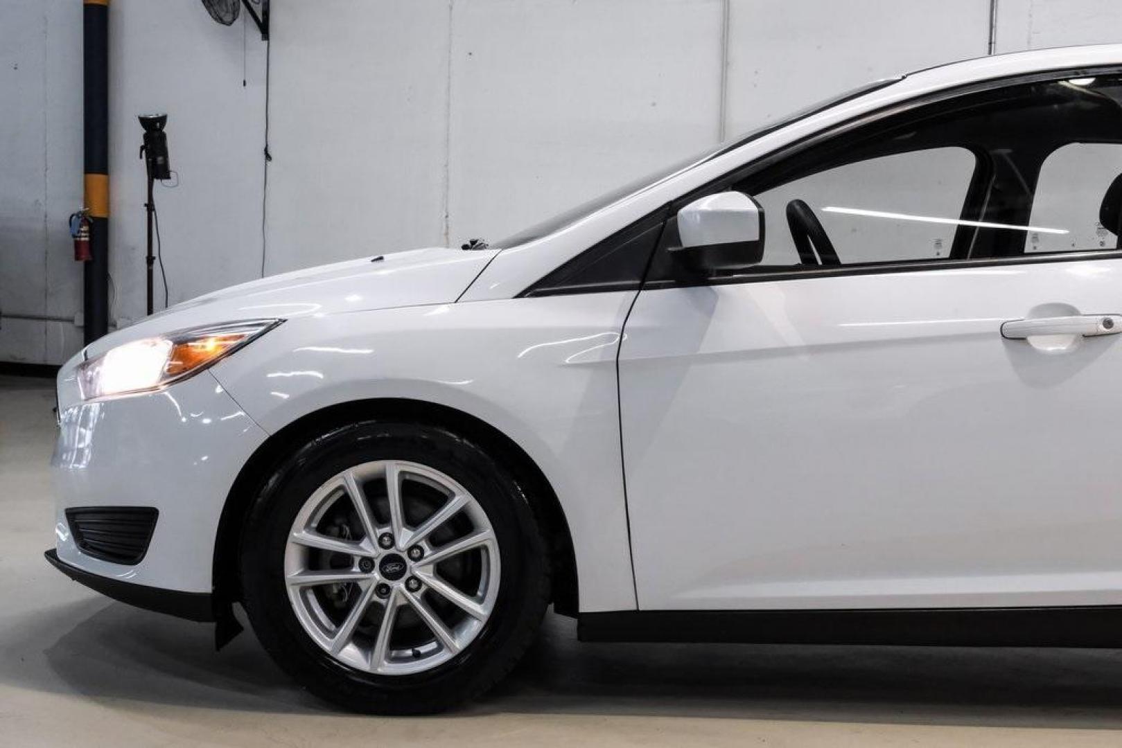 2018 Oxford White /Black Ford Focus SE (1FADP3K23JL) with an 2.0L I4 DGI Ti-VCT engine, Automatic transmission, located at 15300 Midway Rd., Addison, TX, 75001, (972) 702-0011, 32.958321, -96.838074 - 2018 Ford Focus SE<br><br>Now Available at Midway Auto Group, Addison, Texas<br><br>Efficient, comfortable, and great for everyday driving the 2018 Ford Focus SE delivers excellent fuel economy, modern technology, and a smooth, enjoyable ride. Whether you're commuting across DFW, shopping for a firs - Photo#10