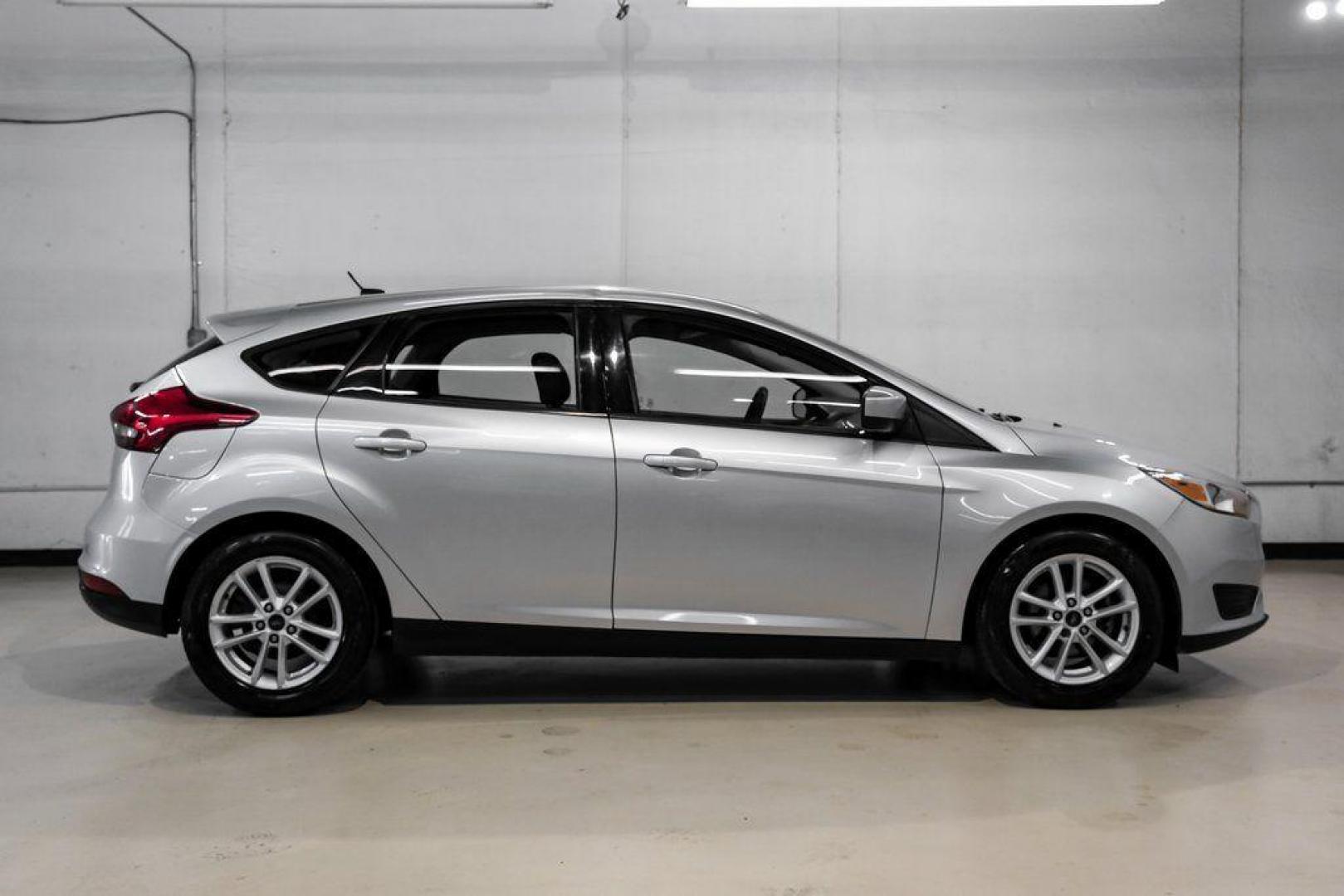 2018 Ingot Silver /Charcoal Black Ford Focus SE (1FADP3K28JL) with an 2.0L I4 DGI Ti-VCT engine, Automatic transmission, located at 15300 Midway Rd., Addison, TX, 75001, (972) 702-0011, 32.958321, -96.838074 - Photo#8