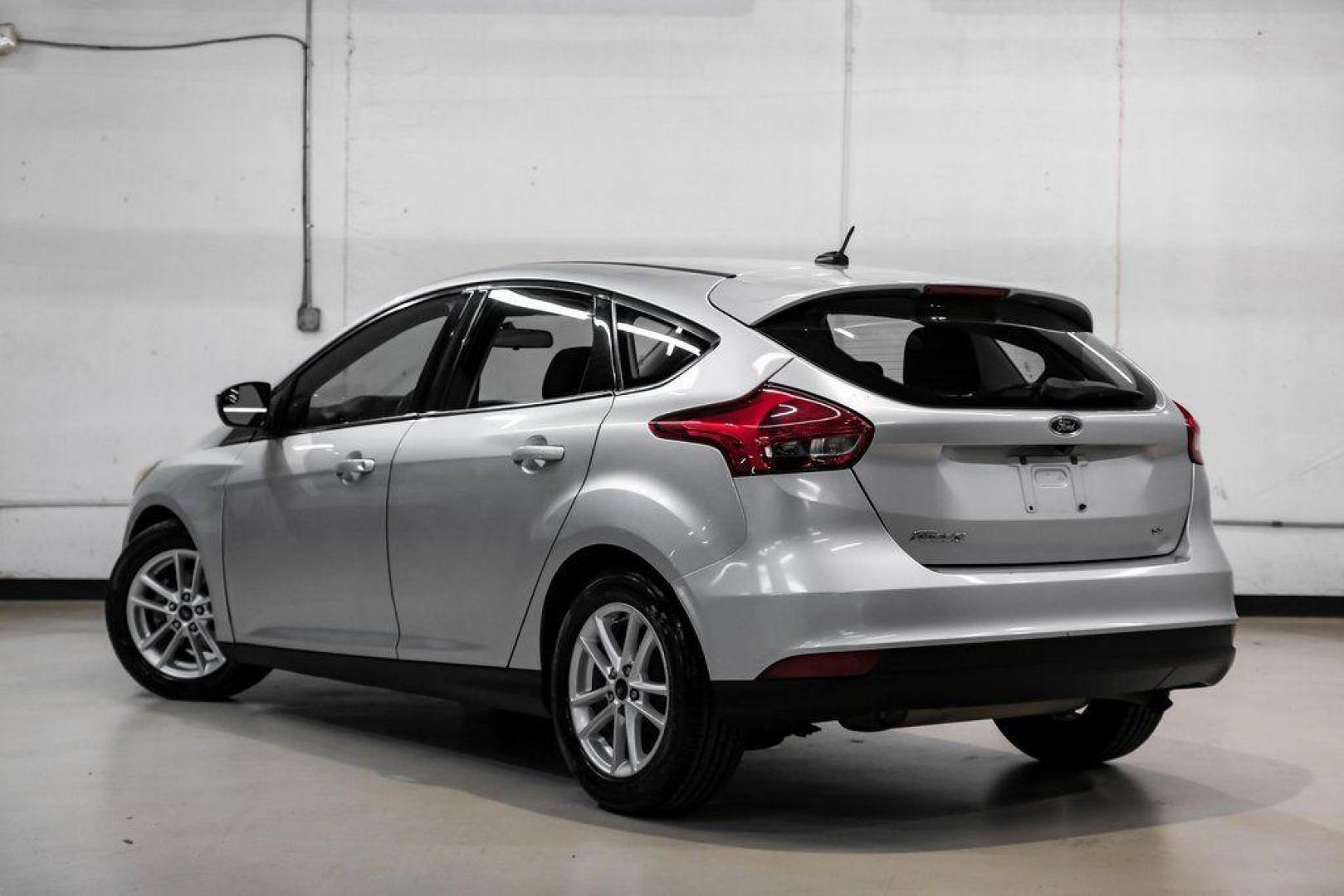 2018 Ingot Silver /Charcoal Black Ford Focus SE (1FADP3K28JL) with an 2.0L I4 DGI Ti-VCT engine, Automatic transmission, located at 15300 Midway Rd., Addison, TX, 75001, (972) 702-0011, 32.958321, -96.838074 - Photo#11