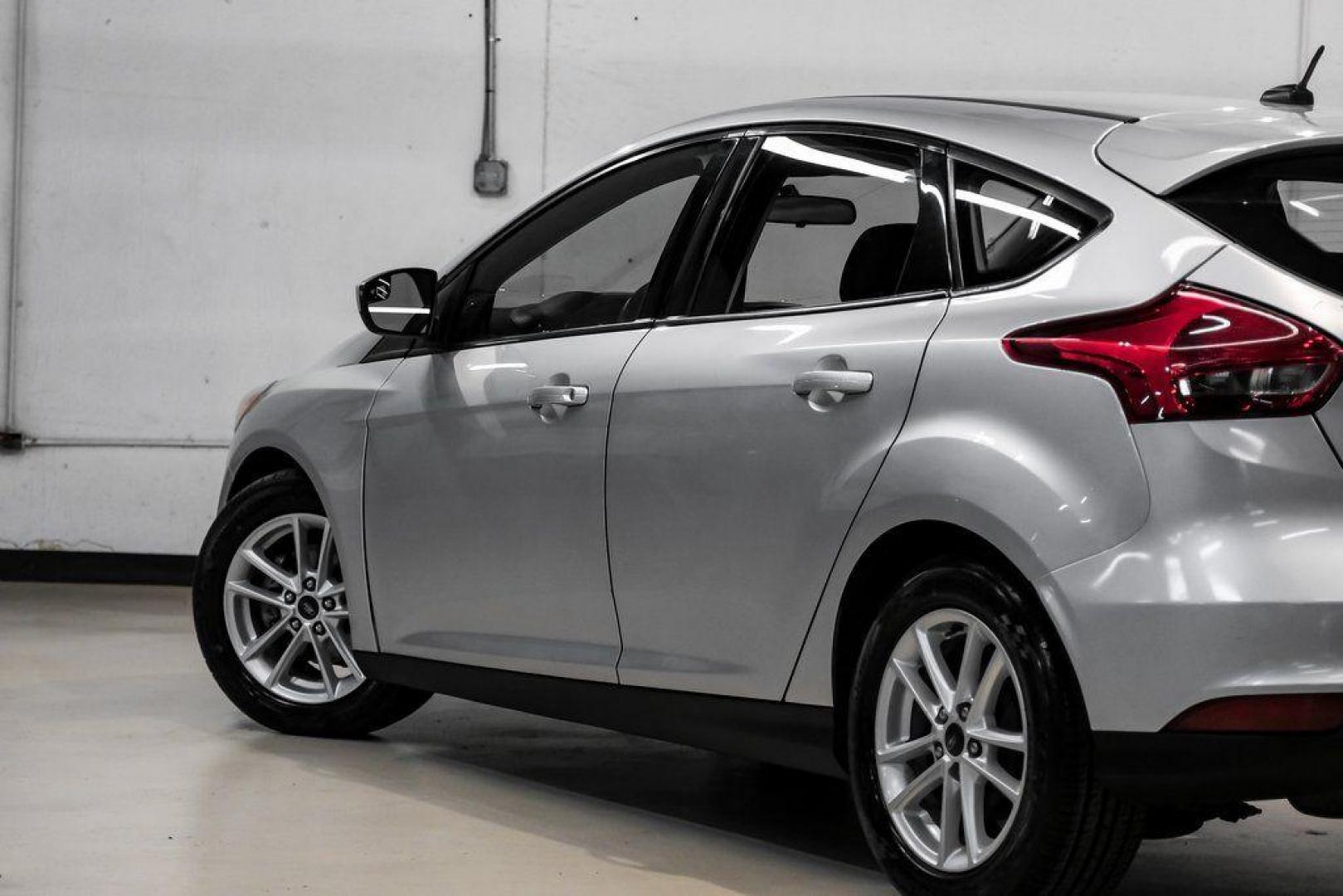 2018 Ingot Silver /Charcoal Black Ford Focus SE (1FADP3K28JL) with an 2.0L I4 DGI Ti-VCT engine, Automatic transmission, located at 15300 Midway Rd., Addison, TX, 75001, (972) 702-0011, 32.958321, -96.838074 - Photo#12