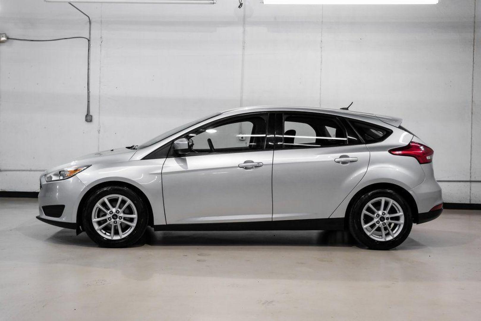 2018 Ingot Silver /Charcoal Black Ford Focus SE (1FADP3K28JL) with an 2.0L I4 DGI Ti-VCT engine, Automatic transmission, located at 15300 Midway Rd., Addison, TX, 75001, (972) 702-0011, 32.958321, -96.838074 - Photo#14