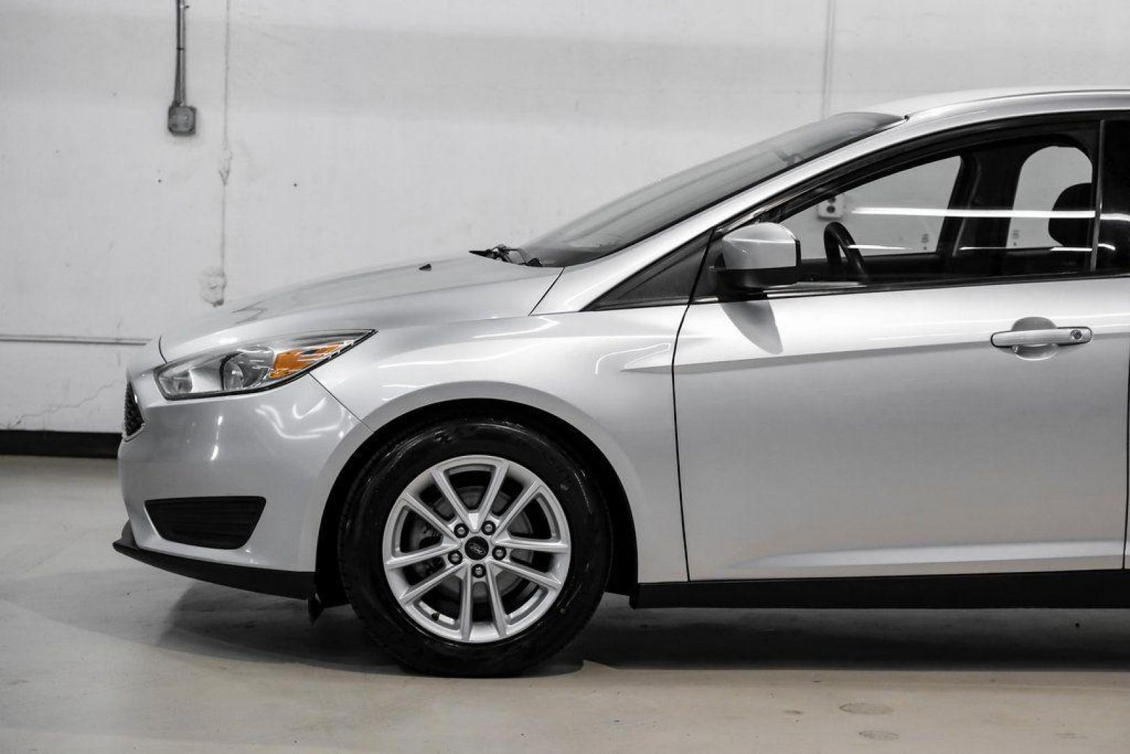 2018 Ingot Silver /Charcoal Black Ford Focus SE (1FADP3K28JL) with an 2.0L I4 DGI Ti-VCT engine, Automatic transmission, located at 15300 Midway Rd., Addison, TX, 75001, (972) 702-0011, 32.958321, -96.838074 - Photo#15