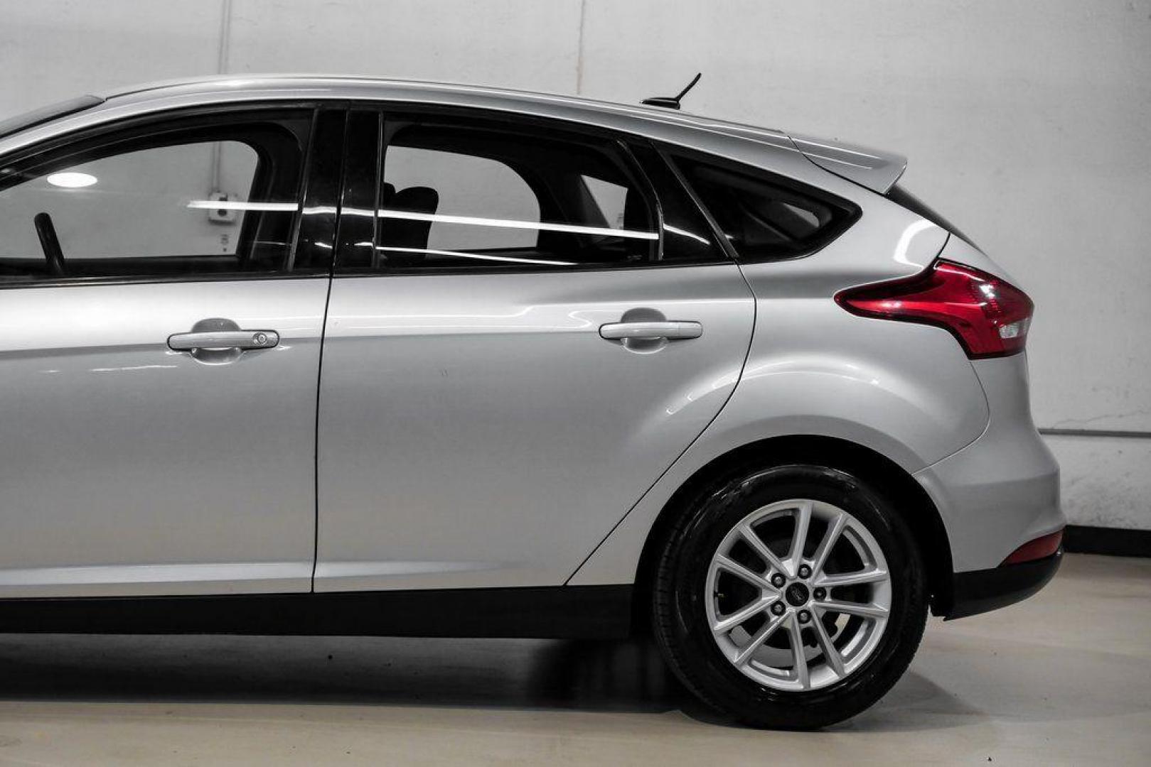 2018 Ingot Silver /Charcoal Black Ford Focus SE (1FADP3K28JL) with an 2.0L I4 DGI Ti-VCT engine, Automatic transmission, located at 15300 Midway Rd., Addison, TX, 75001, (972) 702-0011, 32.958321, -96.838074 - Photo#16