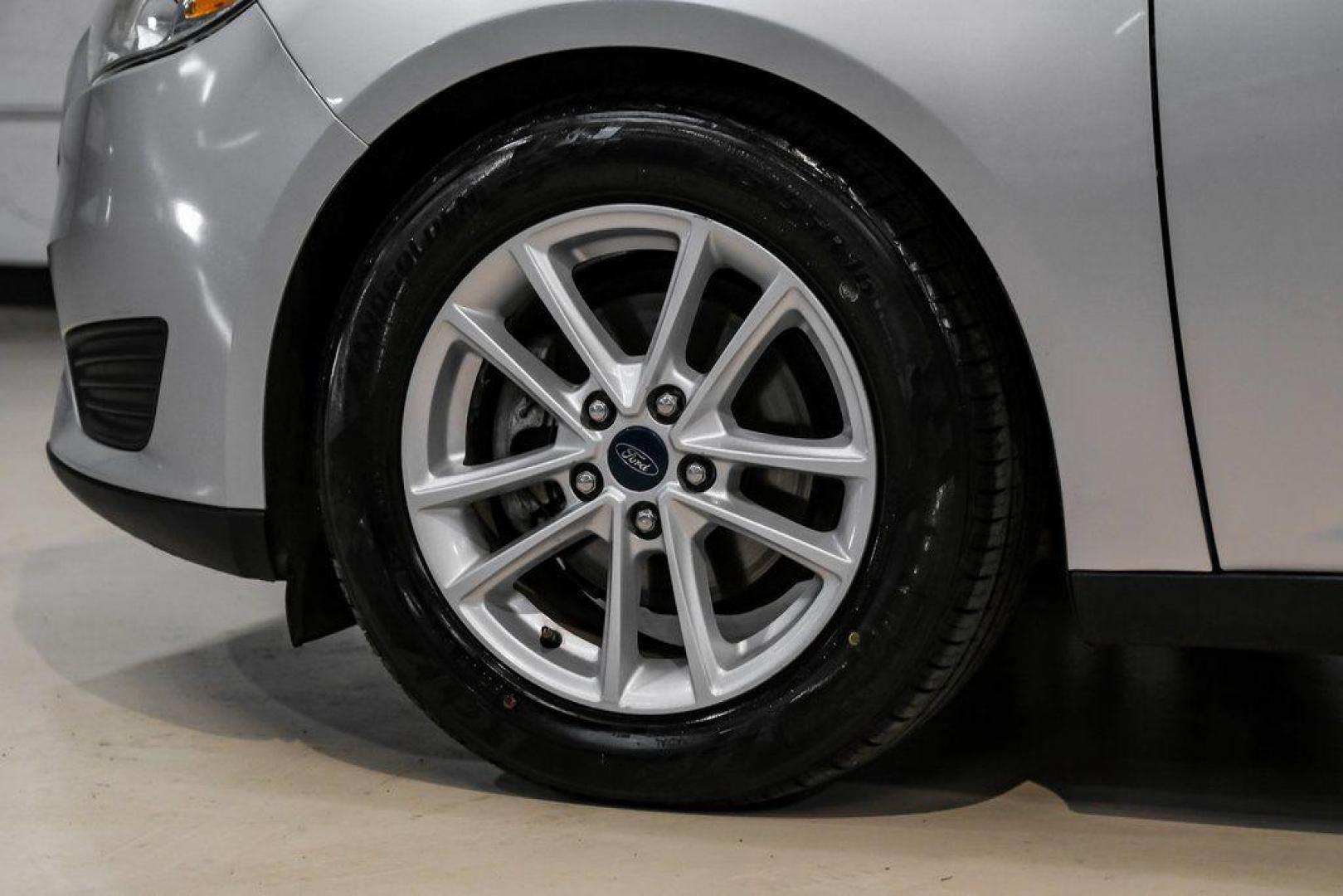 2018 Ingot Silver /Charcoal Black Ford Focus SE (1FADP3K28JL) with an 2.0L I4 DGI Ti-VCT engine, Automatic transmission, located at 15300 Midway Rd., Addison, TX, 75001, (972) 702-0011, 32.958321, -96.838074 - Photo#56