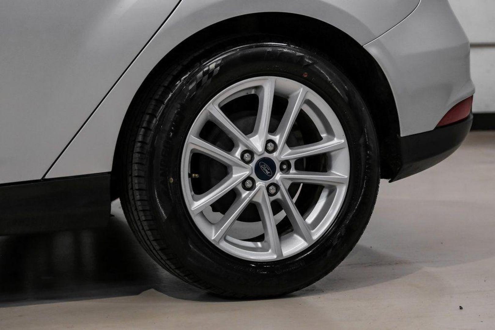 2018 Ingot Silver /Charcoal Black Ford Focus SE (1FADP3K28JL) with an 2.0L I4 DGI Ti-VCT engine, Automatic transmission, located at 15300 Midway Rd., Addison, TX, 75001, (972) 702-0011, 32.958321, -96.838074 - Photo#57