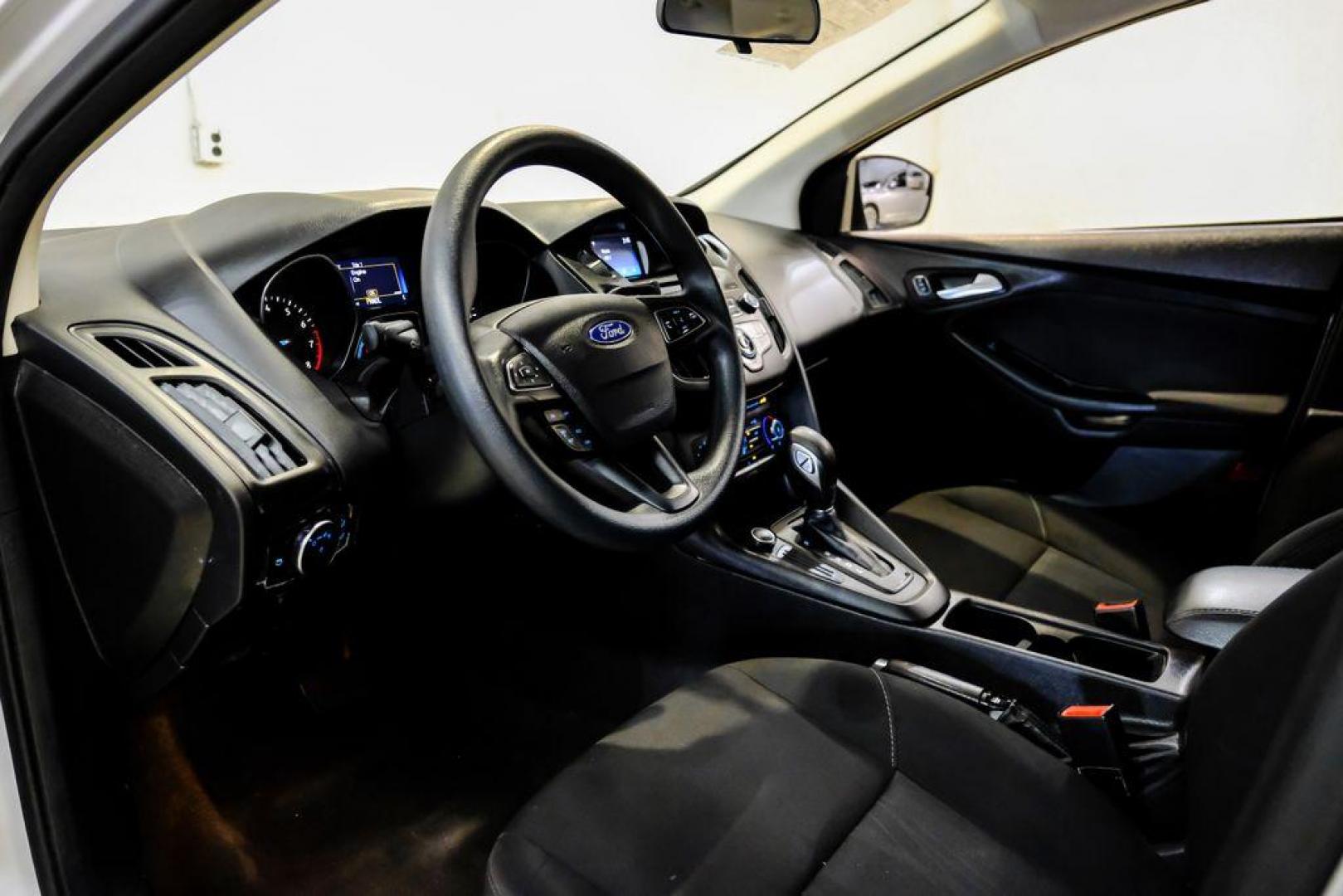 2017 Oxford White /Black Ford Focus SE (1FADP3F23HL) with an 2.0L 4-Cylinder DGI Flex Fuel Turbocharged DOHC engine, Automatic transmission, located at 15300 Midway Rd., Addison, TX, 75001, (972) 702-0011, 32.958321, -96.838074 - Photo#2