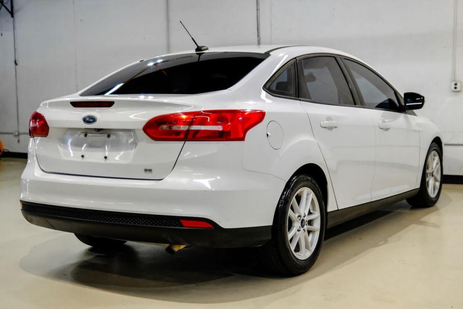 2017 Oxford White /Black Ford Focus SE (1FADP3F23HL) with an 2.0L 4-Cylinder DGI Flex Fuel Turbocharged DOHC engine, Automatic transmission, located at 15300 Midway Rd., Addison, TX, 75001, (972) 702-0011, 32.958321, -96.838074 - Photo#5