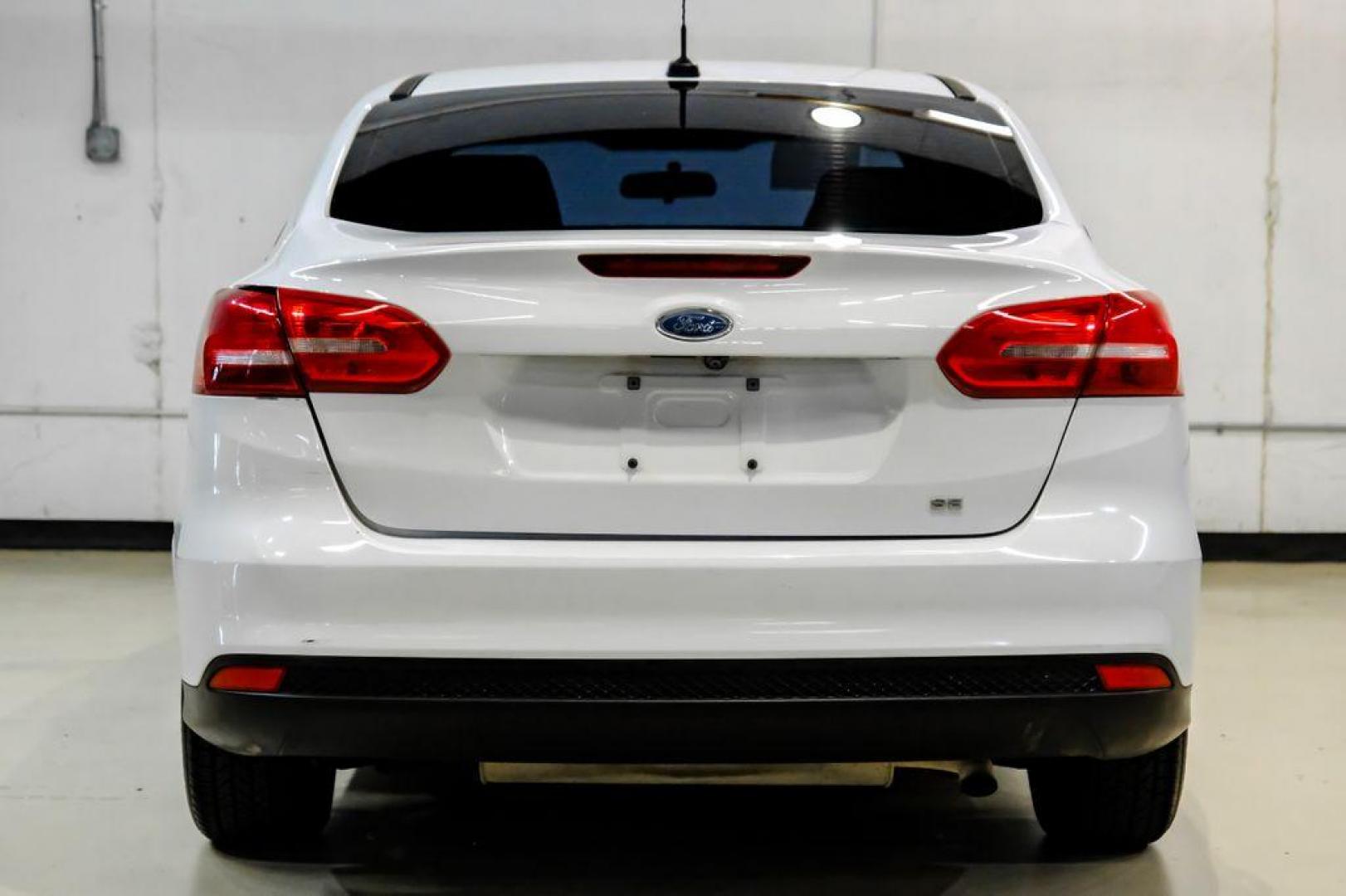 2017 Oxford White /Black Ford Focus SE (1FADP3F23HL) with an 2.0L 4-Cylinder DGI Flex Fuel Turbocharged DOHC engine, Automatic transmission, located at 15300 Midway Rd., Addison, TX, 75001, (972) 702-0011, 32.958321, -96.838074 - Photo#6