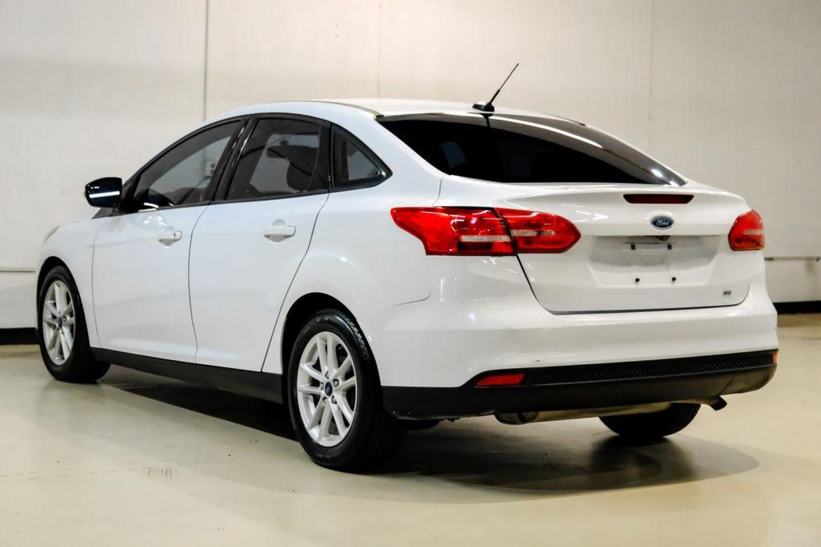 2017 Oxford White /Black Ford Focus SE (1FADP3F23HL) with an 2.0L 4-Cylinder DGI Flex Fuel Turbocharged DOHC engine, Automatic transmission, located at 15300 Midway Rd., Addison, TX, 75001, (972) 702-0011, 32.958321, -96.838074 - Photo#7