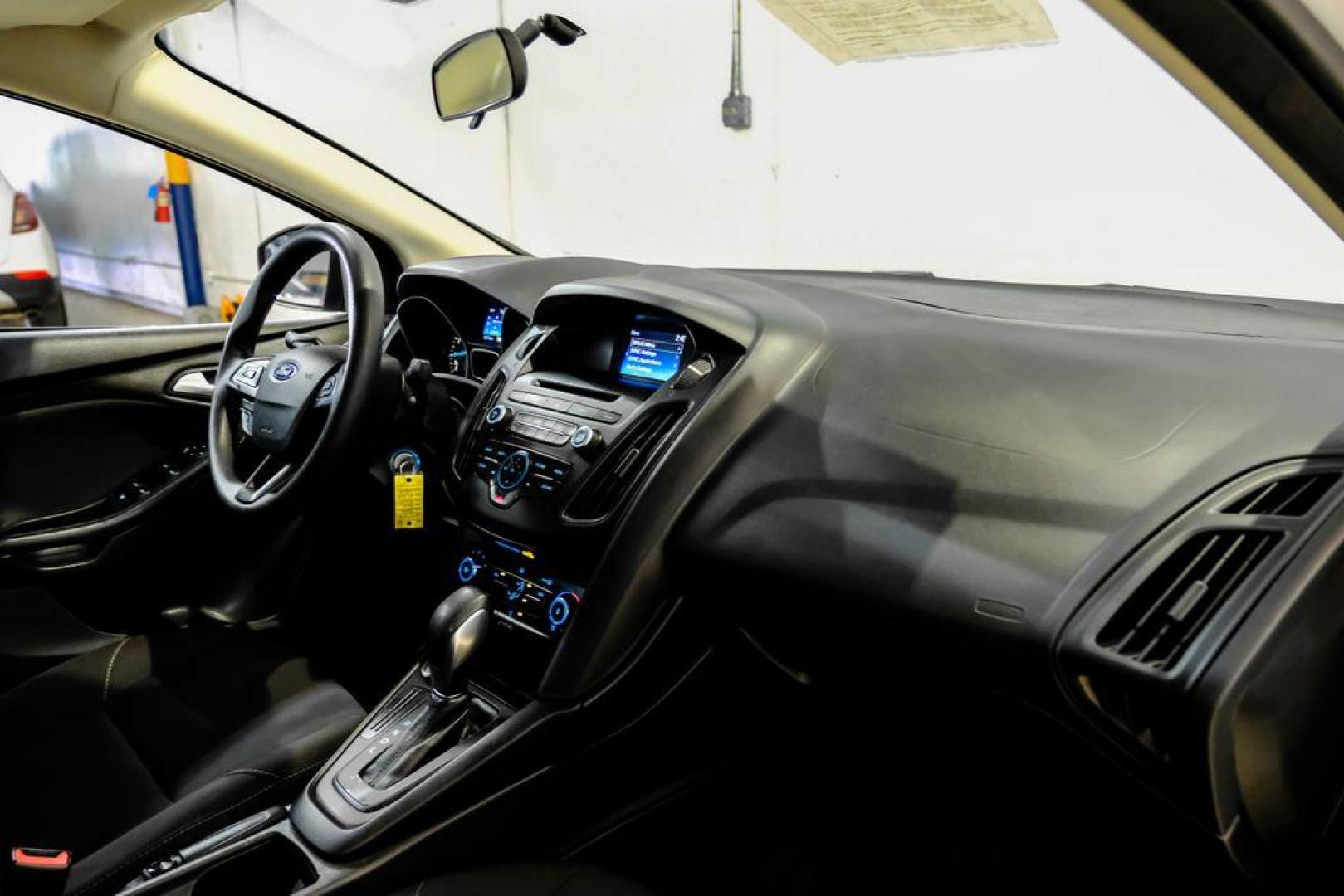 2017 Oxford White /Black Ford Focus SE (1FADP3F23HL) with an 2.0L 4-Cylinder DGI Flex Fuel Turbocharged DOHC engine, Automatic transmission, located at 15300 Midway Rd., Addison, TX, 75001, (972) 702-0011, 32.958321, -96.838074 - Photo#11