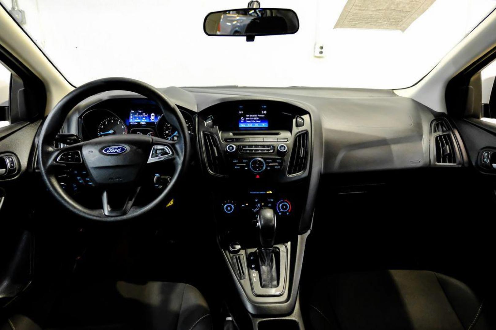 2017 Oxford White /Black Ford Focus SE (1FADP3F23HL) with an 2.0L 4-Cylinder DGI Flex Fuel Turbocharged DOHC engine, Automatic transmission, located at 15300 Midway Rd., Addison, TX, 75001, (972) 702-0011, 32.958321, -96.838074 - Photo#13