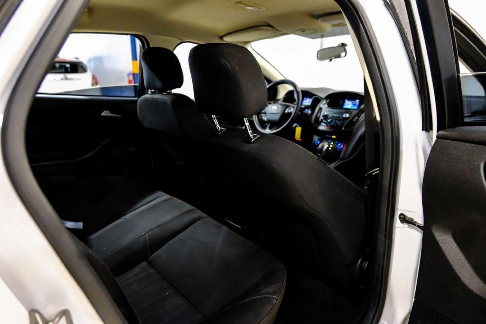 2017 Oxford White /Black Ford Focus SE (1FADP3F23HL) with an 2.0L 4-Cylinder DGI Flex Fuel Turbocharged DOHC engine, Automatic transmission, located at 15300 Midway Rd., Addison, TX, 75001, (972) 702-0011, 32.958321, -96.838074 - Photo#32