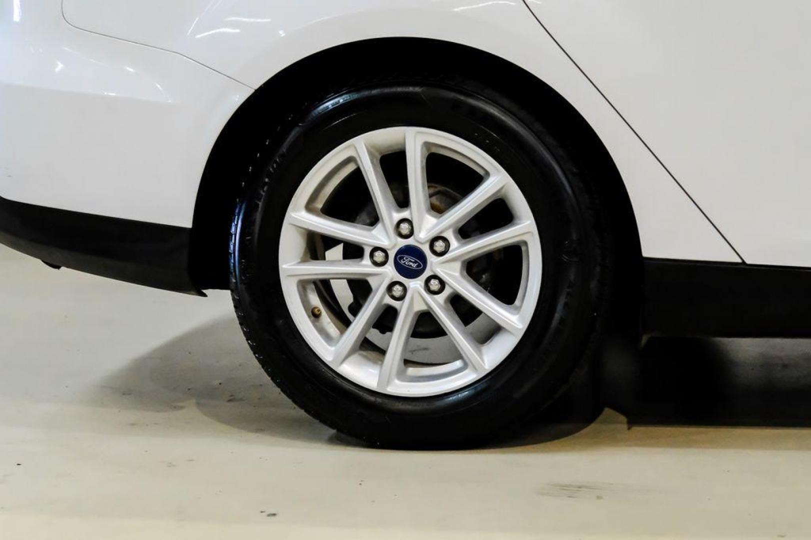 2017 Oxford White /Black Ford Focus SE (1FADP3F23HL) with an 2.0L 4-Cylinder DGI Flex Fuel Turbocharged DOHC engine, Automatic transmission, located at 15300 Midway Rd., Addison, TX, 75001, (972) 702-0011, 32.958321, -96.838074 - Photo#49