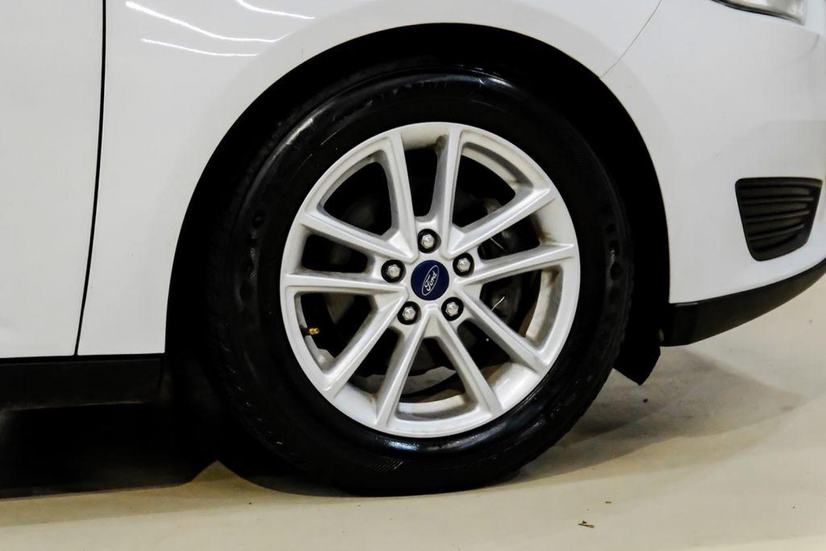 2017 Oxford White /Black Ford Focus SE (1FADP3F23HL) with an 2.0L 4-Cylinder DGI Flex Fuel Turbocharged DOHC engine, Automatic transmission, located at 15300 Midway Rd., Addison, TX, 75001, (972) 702-0011, 32.958321, -96.838074 - Photo#50