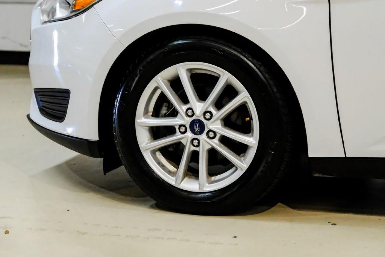 2017 Oxford White /Black Ford Focus SE (1FADP3F23HL) with an 2.0L 4-Cylinder DGI Flex Fuel Turbocharged DOHC engine, Automatic transmission, located at 15300 Midway Rd., Addison, TX, 75001, (972) 702-0011, 32.958321, -96.838074 - Photo#51