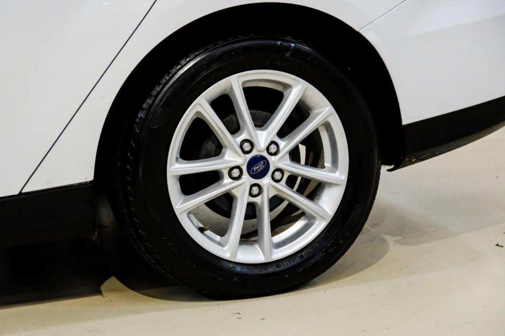 2017 Oxford White /Black Ford Focus SE (1FADP3F23HL) with an 2.0L 4-Cylinder DGI Flex Fuel Turbocharged DOHC engine, Automatic transmission, located at 15300 Midway Rd., Addison, TX, 75001, (972) 702-0011, 32.958321, -96.838074 - Photo#52