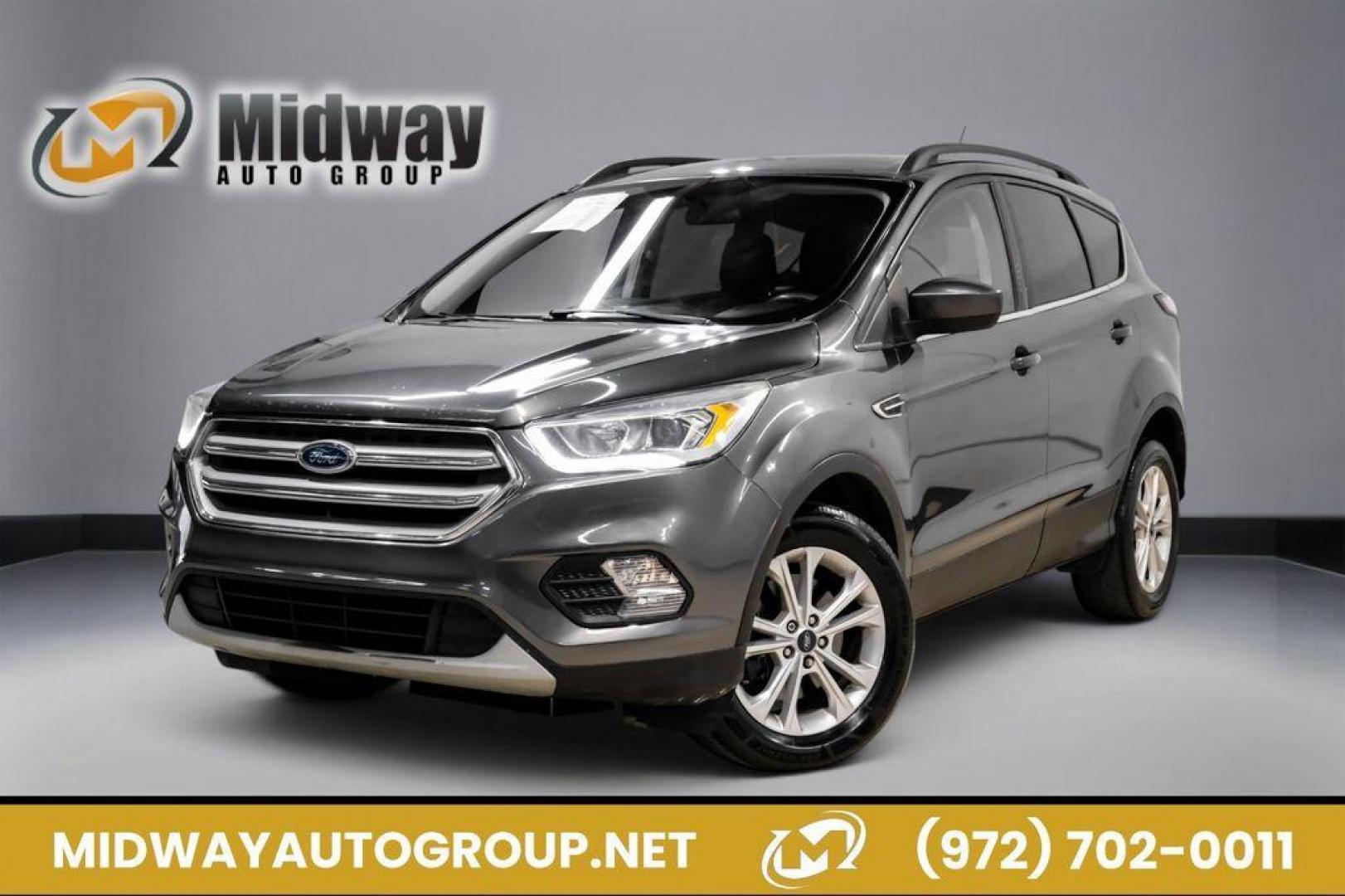 2018 Magnetic Metallic /Charcoal Black Ford Escape SEL (1FMCU9H92JU) with an EcoBoost 2.0L I4 GTDi DOHC Turbocharged VCT engine, Automatic transmission, located at 15300 Midway Rd., Addison, TX, 75001, (972) 702-0011, 32.958321, -96.838074 - Photo#0