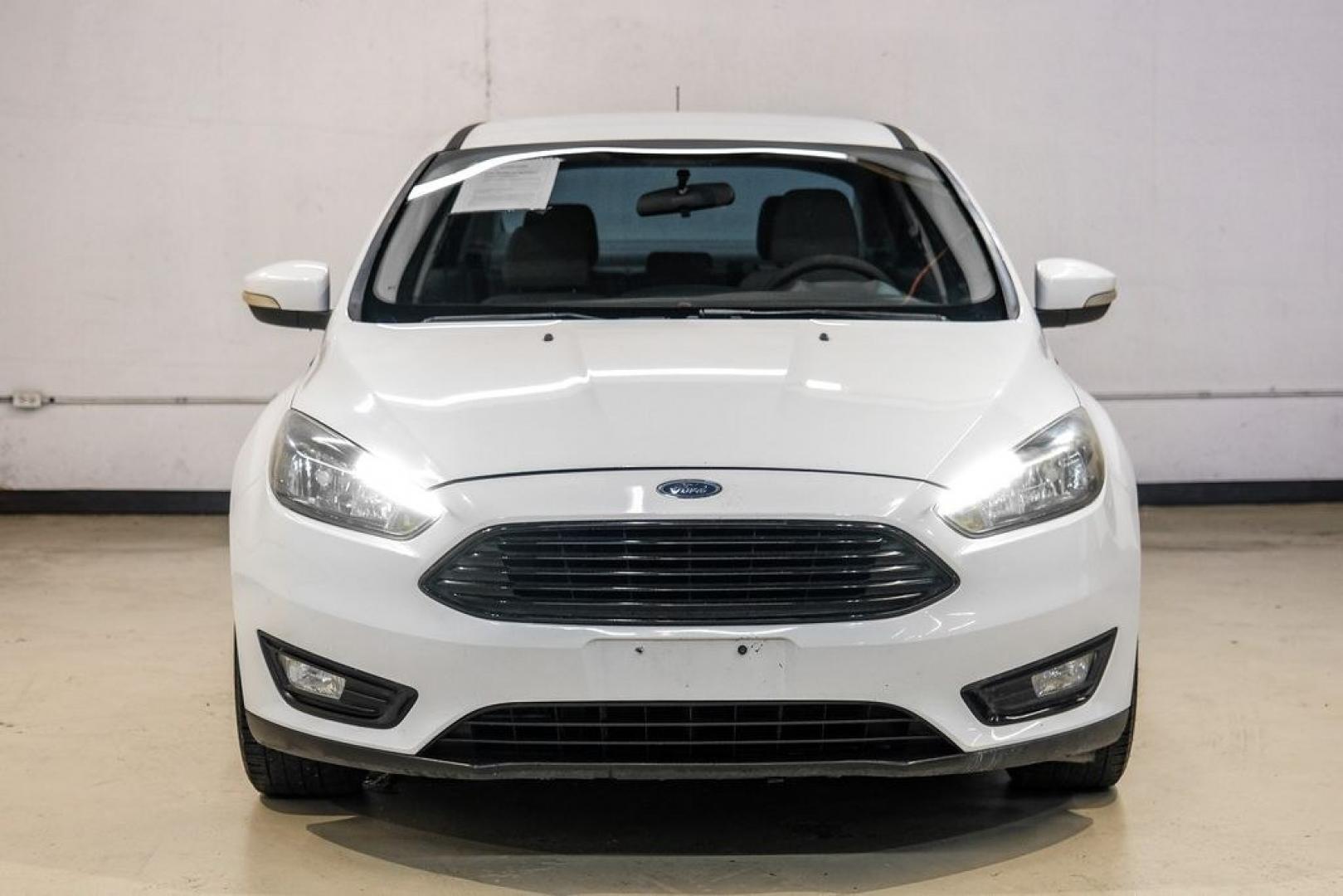 2017 Oxford White /Medium Light Stone Ford Focus SE (1FADP3FE0HL) with an EcoBoost 1.0L I3 GTDi DOHC Turbocharged VCT engine, Automatic transmission, located at 15300 Midway Rd., Addison, TX, 75001, (972) 702-0011, 32.958321, -96.838074- Photo#4