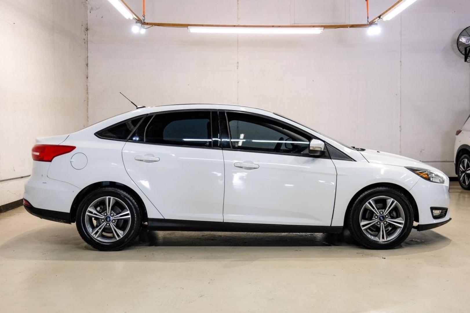 2017 Oxford White /Medium Light Stone Ford Focus SE (1FADP3FE0HL) with an EcoBoost 1.0L I3 GTDi DOHC Turbocharged VCT engine, Automatic transmission, located at 15300 Midway Rd., Addison, TX, 75001, (972) 702-0011, 32.958321, -96.838074- Photo#6