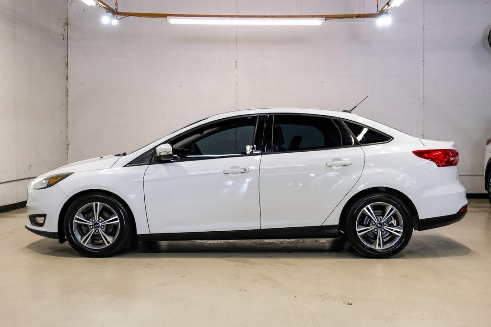 2017 Oxford White /Medium Light Stone Ford Focus SE (1FADP3FE0HL) with an EcoBoost 1.0L I3 GTDi DOHC Turbocharged VCT engine, Automatic transmission, located at 15300 Midway Rd., Addison, TX, 75001, (972) 702-0011, 32.958321, -96.838074- Photo#10