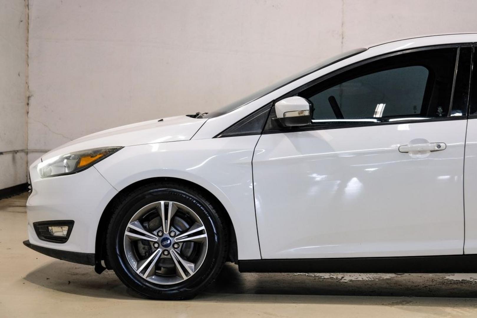 2017 Oxford White /Medium Light Stone Ford Focus SE (1FADP3FE0HL) with an EcoBoost 1.0L I3 GTDi DOHC Turbocharged VCT engine, Automatic transmission, located at 15300 Midway Rd., Addison, TX, 75001, (972) 702-0011, 32.958321, -96.838074- Photo#11