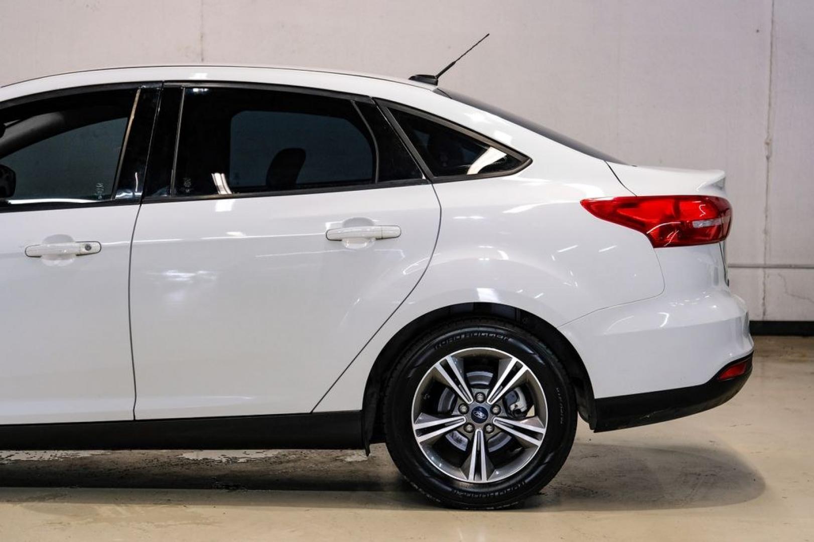 2017 Oxford White /Medium Light Stone Ford Focus SE (1FADP3FE0HL) with an EcoBoost 1.0L I3 GTDi DOHC Turbocharged VCT engine, Automatic transmission, located at 15300 Midway Rd., Addison, TX, 75001, (972) 702-0011, 32.958321, -96.838074- Photo#12