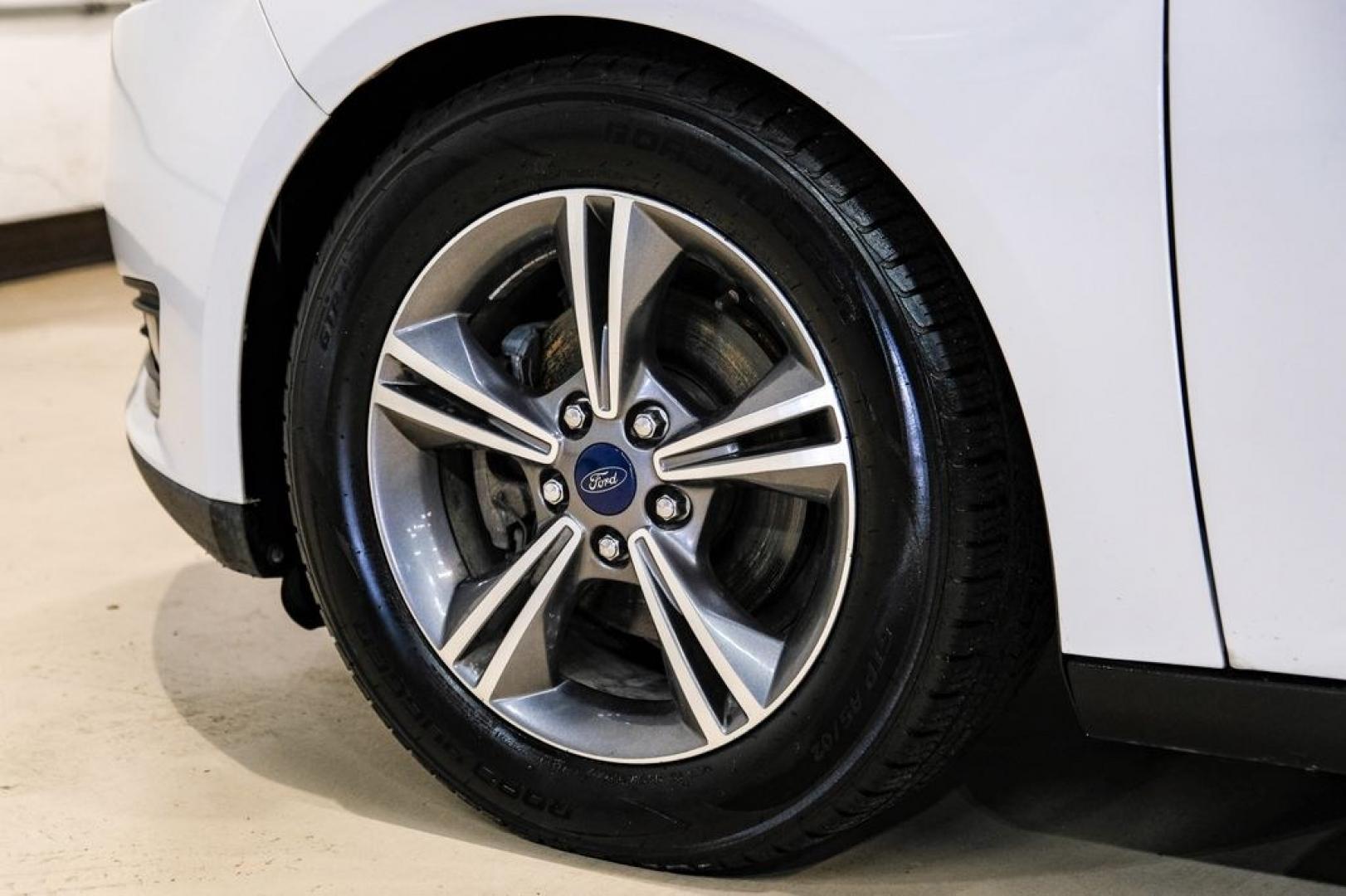 2017 Oxford White /Medium Light Stone Ford Focus SE (1FADP3FE0HL) with an EcoBoost 1.0L I3 GTDi DOHC Turbocharged VCT engine, Automatic transmission, located at 15300 Midway Rd., Addison, TX, 75001, (972) 702-0011, 32.958321, -96.838074- Photo#53