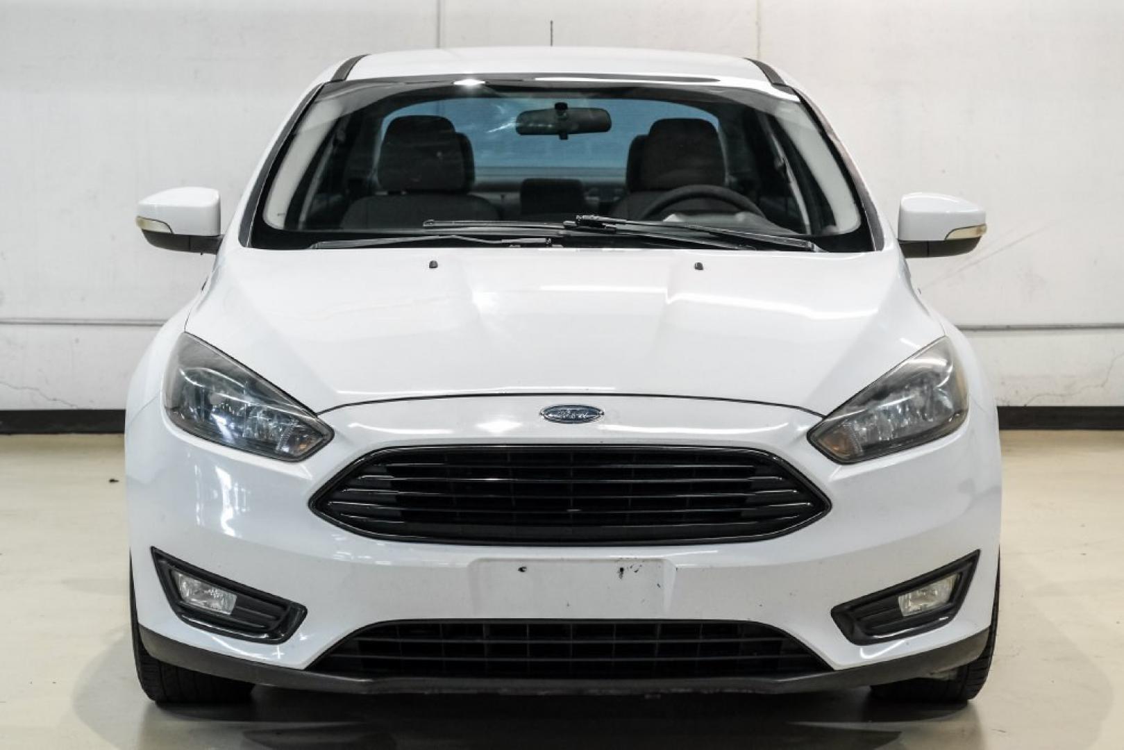 2017 Oxford White /Medium Light Stone Ford Focus SE (1FADP3FE0HL) with an EcoBoost 1.0L I3 GTDi DOHC Turbocharged VCT engine, Automatic transmission, located at 15300 Midway Rd., Addison, TX, 75001, (972) 702-0011, 32.958321, -96.838074- Photo#4