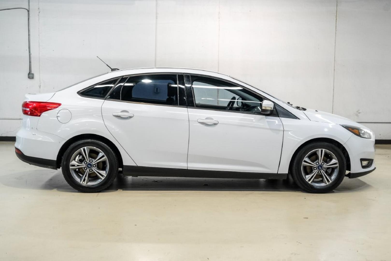 2017 Oxford White /Medium Light Stone Ford Focus SE (1FADP3FE0HL) with an EcoBoost 1.0L I3 GTDi DOHC Turbocharged VCT engine, Automatic transmission, located at 15300 Midway Rd., Addison, TX, 75001, (972) 702-0011, 32.958321, -96.838074- Photo#6