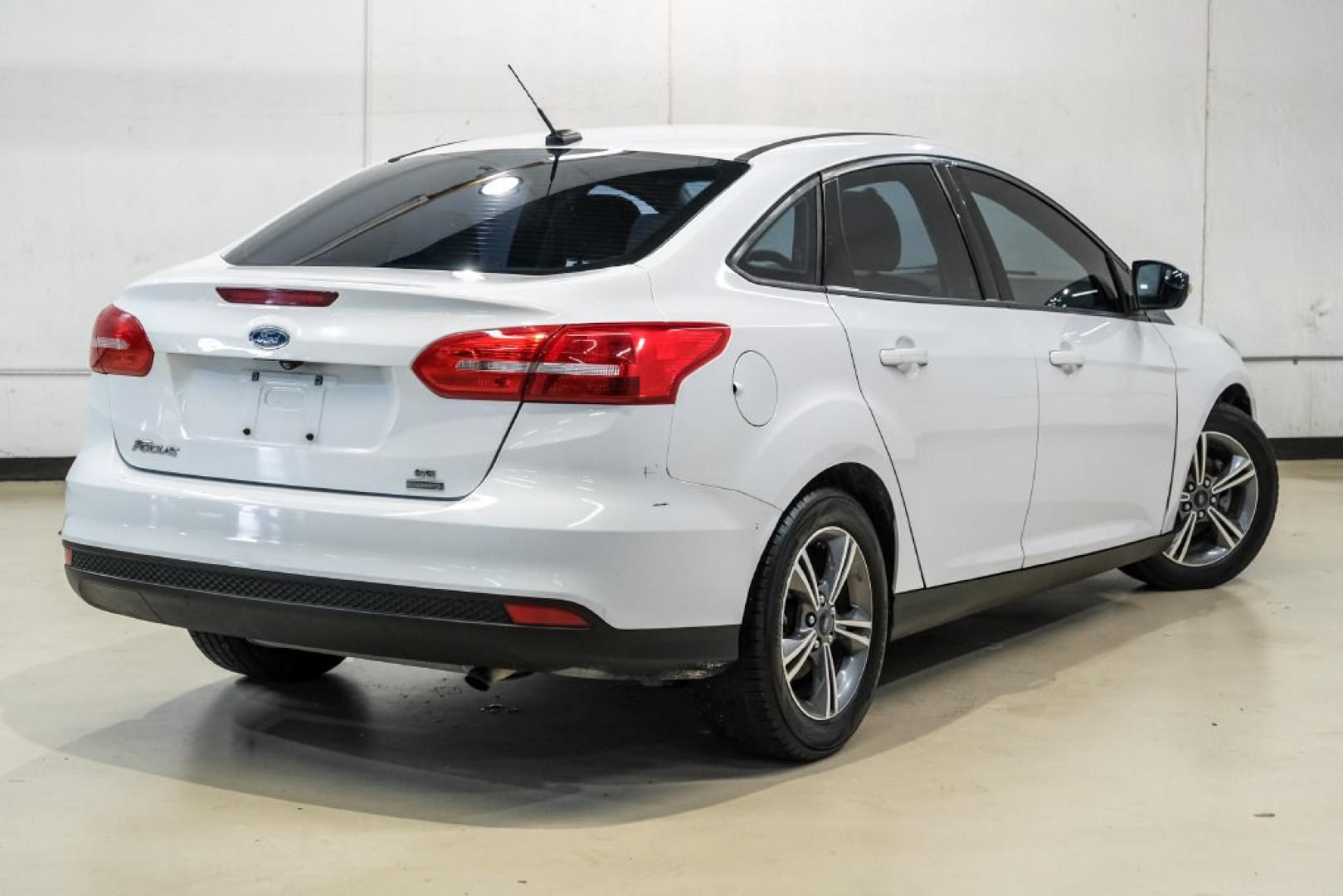 2017 Oxford White /Medium Light Stone Ford Focus SE (1FADP3FE0HL) with an EcoBoost 1.0L I3 GTDi DOHC Turbocharged VCT engine, Automatic transmission, located at 15300 Midway Rd., Addison, TX, 75001, (972) 702-0011, 32.958321, -96.838074- Photo#7