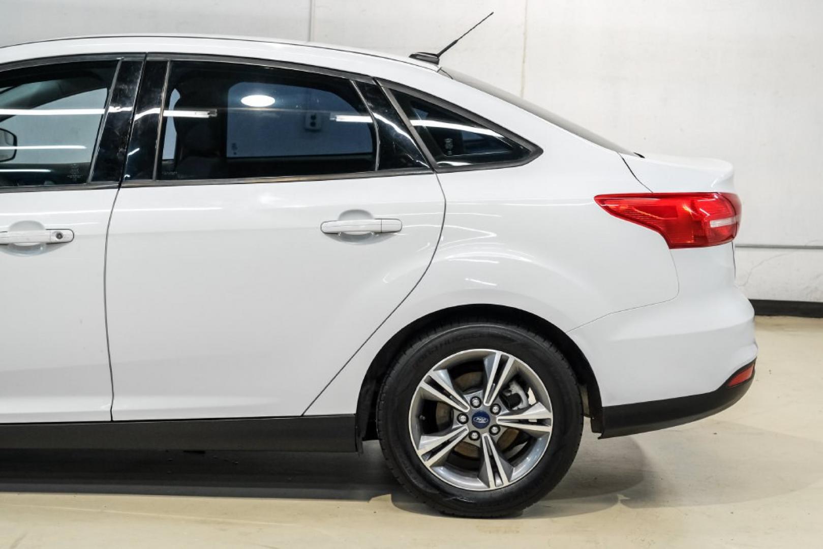 2017 Oxford White /Medium Light Stone Ford Focus SE (1FADP3FE0HL) with an EcoBoost 1.0L I3 GTDi DOHC Turbocharged VCT engine, Automatic transmission, located at 15300 Midway Rd., Addison, TX, 75001, (972) 702-0011, 32.958321, -96.838074- Photo#12
