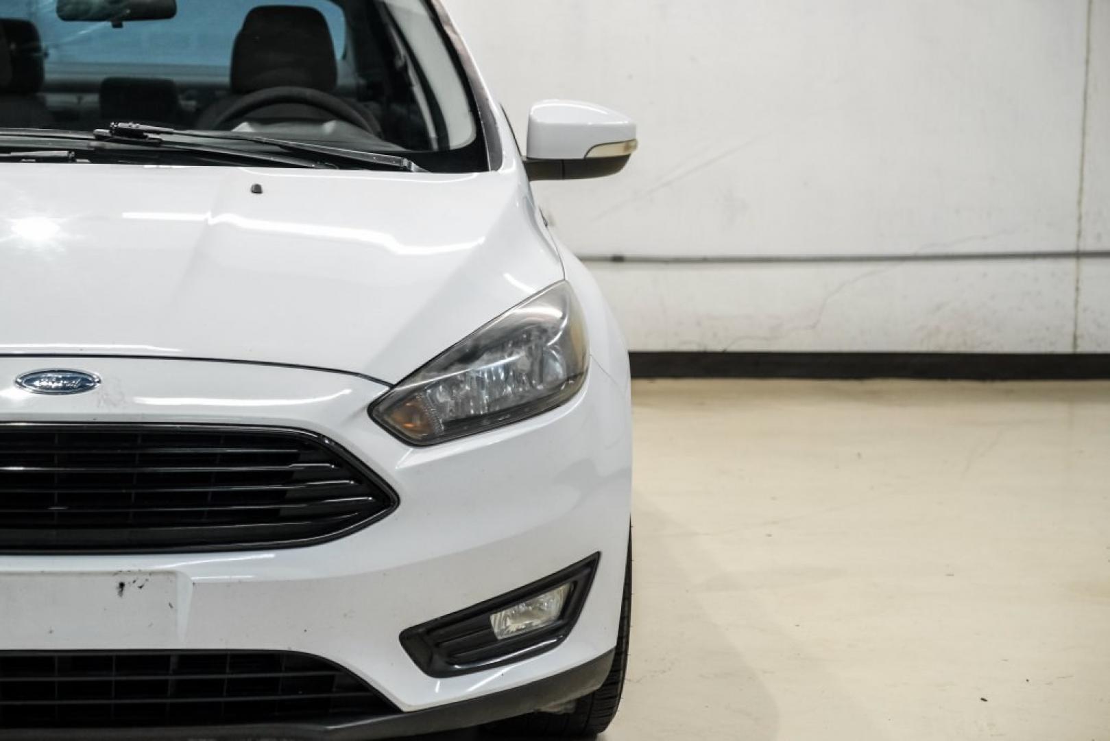 2017 Oxford White /Medium Light Stone Ford Focus SE (1FADP3FE0HL) with an EcoBoost 1.0L I3 GTDi DOHC Turbocharged VCT engine, Automatic transmission, located at 15300 Midway Rd., Addison, TX, 75001, (972) 702-0011, 32.958321, -96.838074- Photo#45