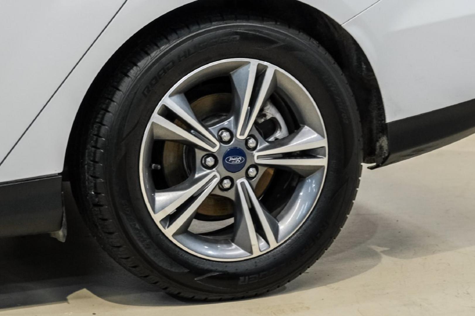 2017 Oxford White /Medium Light Stone Ford Focus SE (1FADP3FE0HL) with an EcoBoost 1.0L I3 GTDi DOHC Turbocharged VCT engine, Automatic transmission, located at 15300 Midway Rd., Addison, TX, 75001, (972) 702-0011, 32.958321, -96.838074- Photo#53