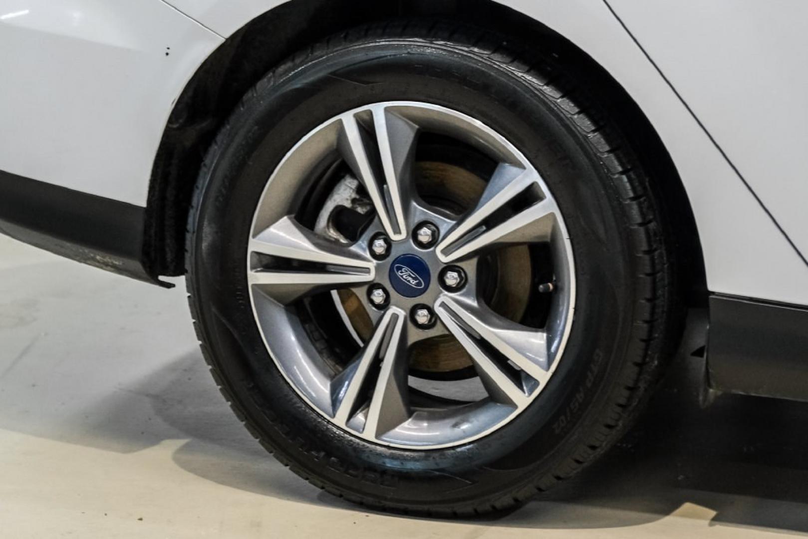 2017 Oxford White /Medium Light Stone Ford Focus SE (1FADP3FE0HL) with an EcoBoost 1.0L I3 GTDi DOHC Turbocharged VCT engine, Automatic transmission, located at 15300 Midway Rd., Addison, TX, 75001, (972) 702-0011, 32.958321, -96.838074- Photo#54