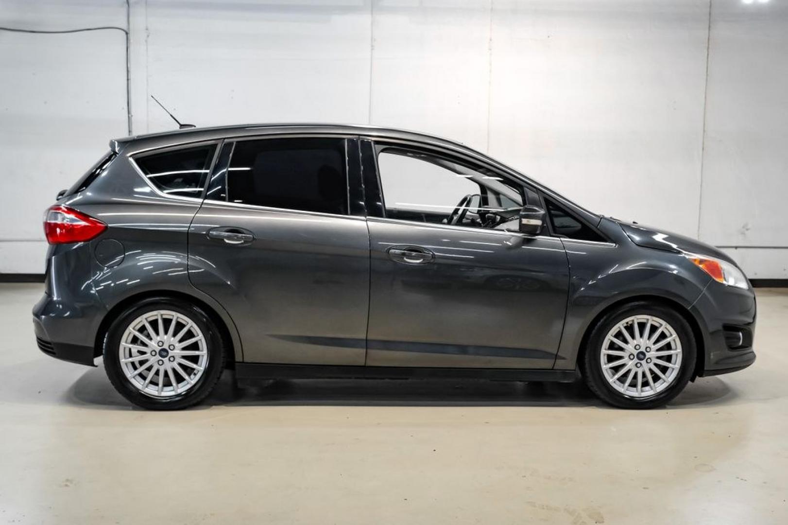 2015 Magnetic /Medium Light Stone Ford C-Max Energi SEL (1FADP5CUXFL) with an I4 Hybrid engine, CVT transmission, located at 15300 Midway Rd., Addison, TX, 75001, (972) 702-0011, 32.958321, -96.838074- Photo#7