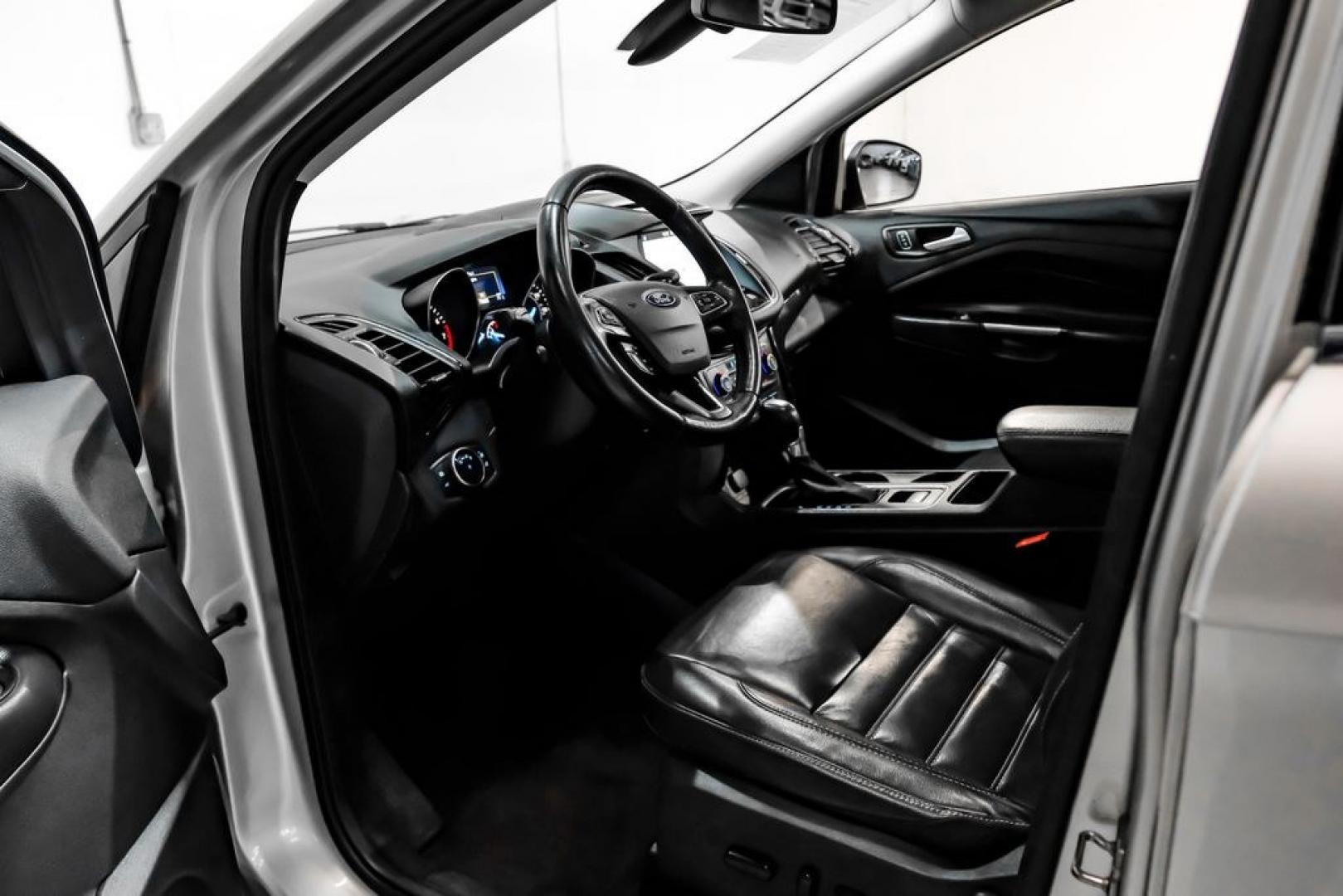 2017 Ingot Silver /Black Ford Escape Titanium (1FMCU0JD8HU) with an 1.5L EcoBoost engine, Automatic transmission, located at 15300 Midway Rd., Addison, TX, 75001, (972) 702-0011, 32.958321, -96.838074- Photo#2
