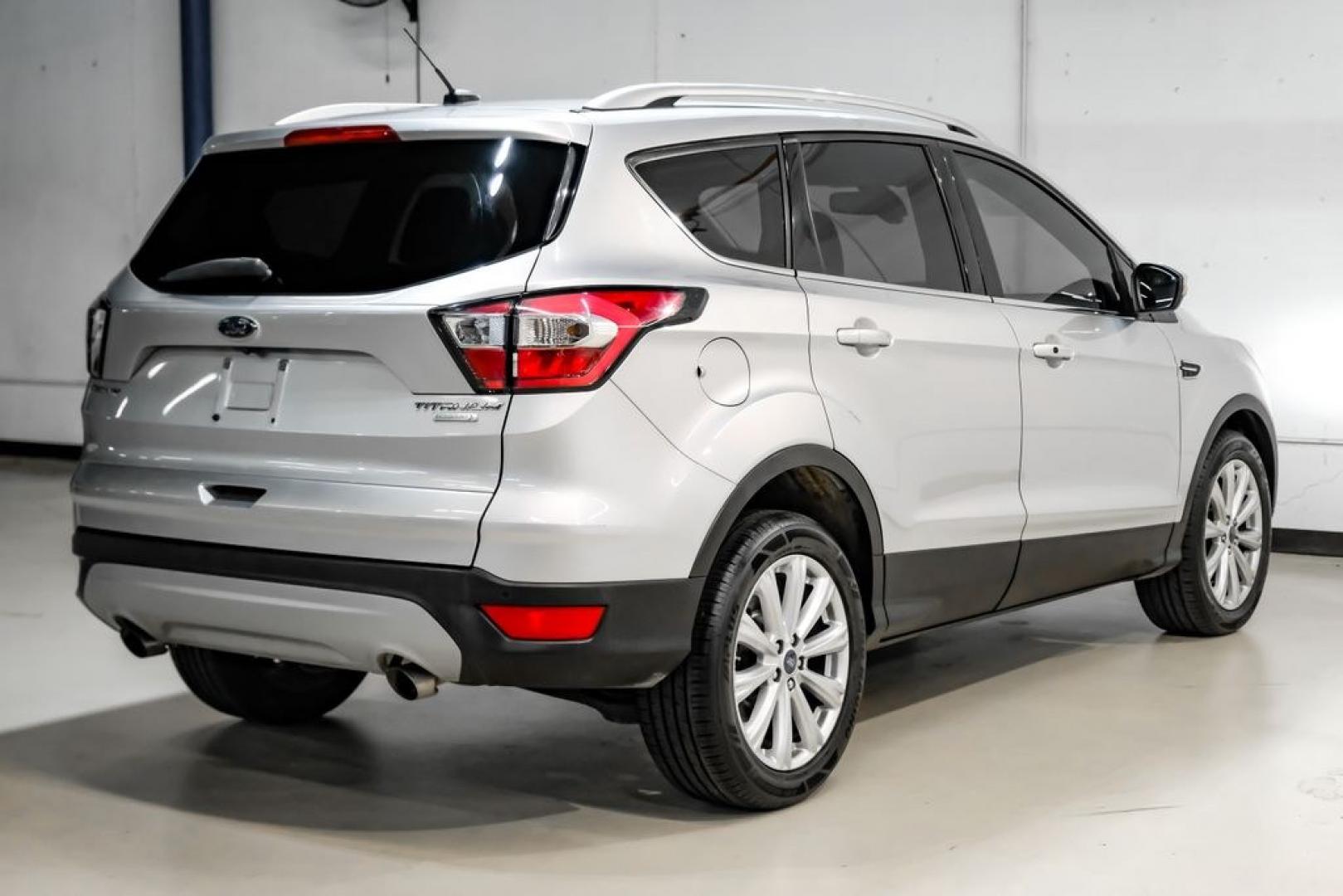 2017 Ingot Silver /Black Ford Escape Titanium (1FMCU0JD8HU) with an 1.5L EcoBoost engine, Automatic transmission, located at 15300 Midway Rd., Addison, TX, 75001, (972) 702-0011, 32.958321, -96.838074- Photo#7