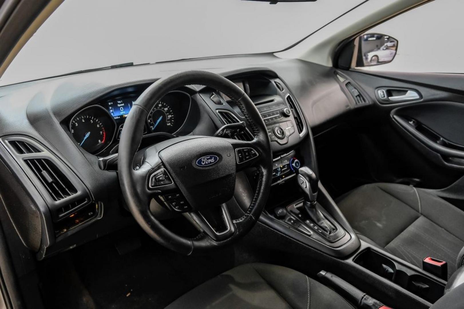 2016 Magnetic /Black Ford Focus SE (1FADP3F22GL) with an 2.0L 4-Cylinder DGI Flex Fuel DOHC engine, Automatic transmission, located at 15300 Midway Rd., Addison, TX, 75001, (972) 702-0011, 32.958321, -96.838074- Photo#2