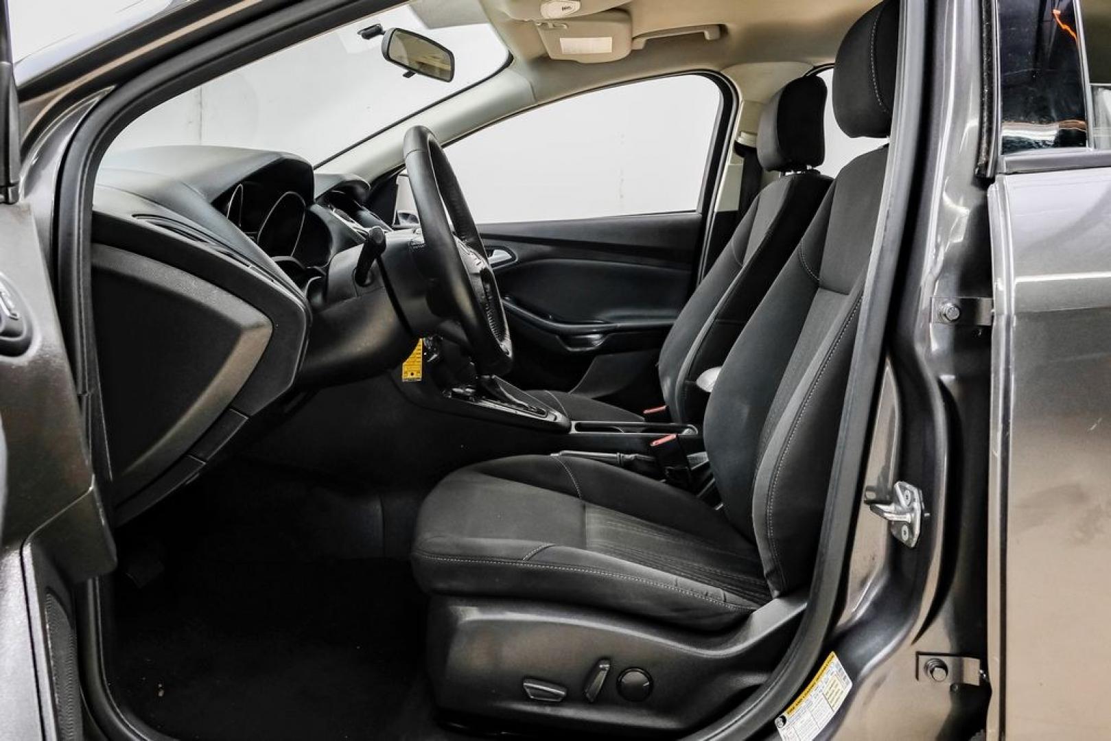 2016 Magnetic /Black Ford Focus SE (1FADP3F22GL) with an 2.0L 4-Cylinder DGI Flex Fuel DOHC engine, Automatic transmission, located at 15300 Midway Rd., Addison, TX, 75001, (972) 702-0011, 32.958321, -96.838074- Photo#3