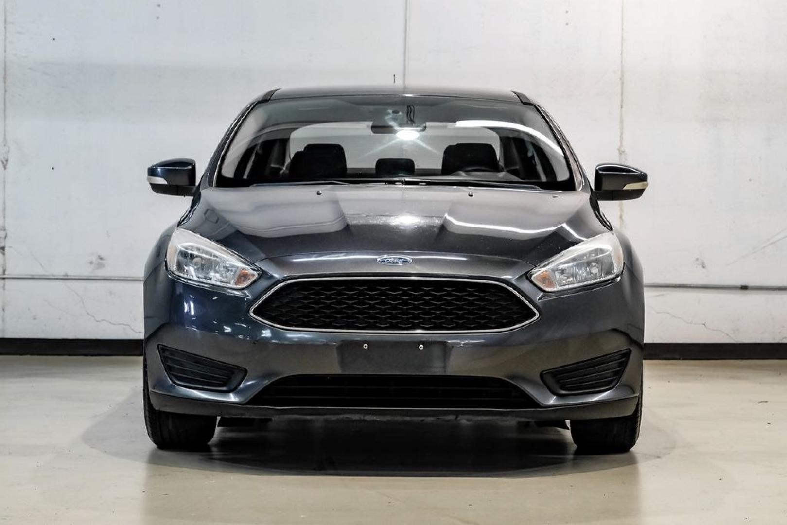 2016 Magnetic /Black Ford Focus SE (1FADP3F22GL) with an 2.0L 4-Cylinder DGI Flex Fuel DOHC engine, Automatic transmission, located at 15300 Midway Rd., Addison, TX, 75001, (972) 702-0011, 32.958321, -96.838074- Photo#6