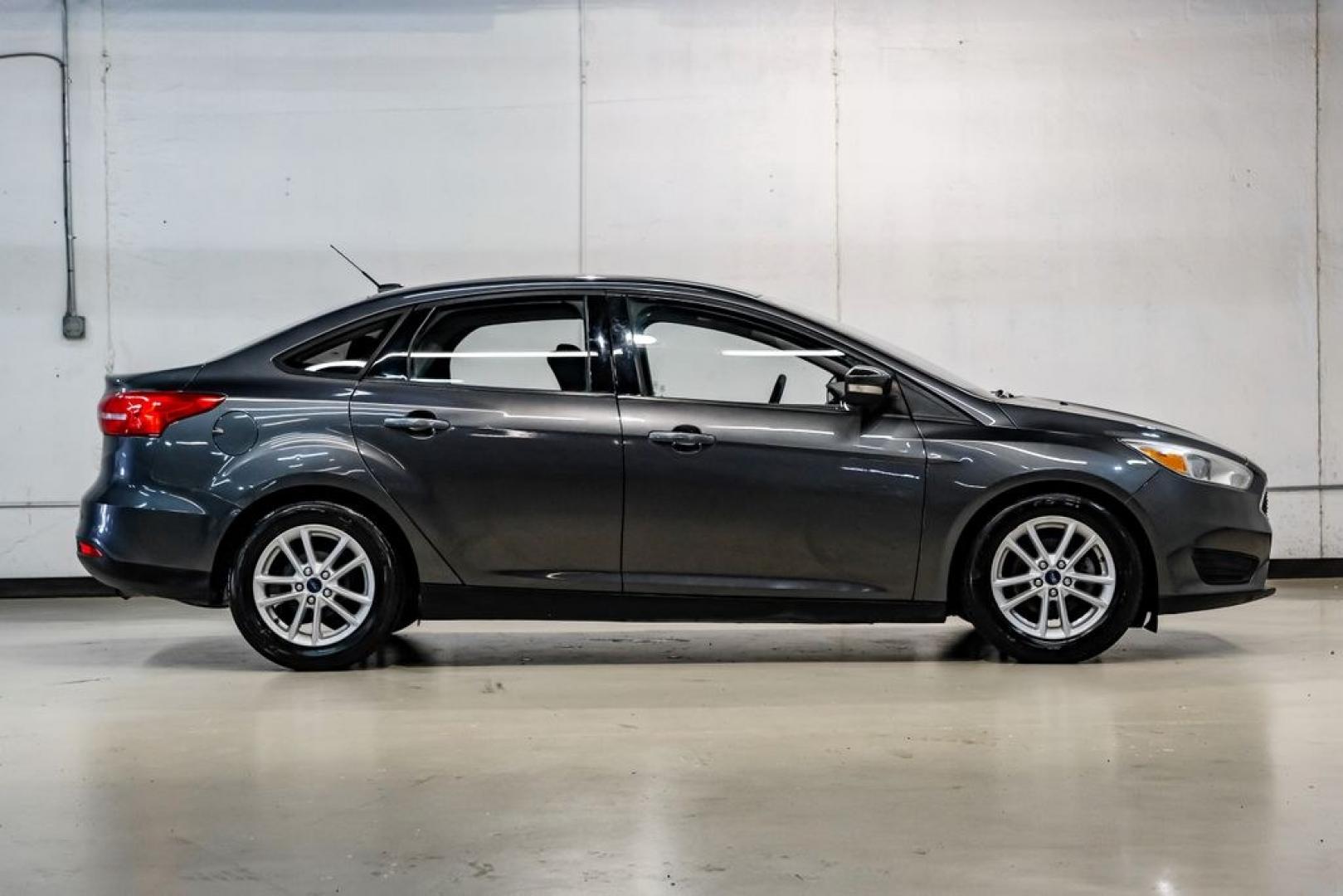 2016 Magnetic /Black Ford Focus SE (1FADP3F22GL) with an 2.0L 4-Cylinder DGI Flex Fuel DOHC engine, Automatic transmission, located at 15300 Midway Rd., Addison, TX, 75001, (972) 702-0011, 32.958321, -96.838074- Photo#8
