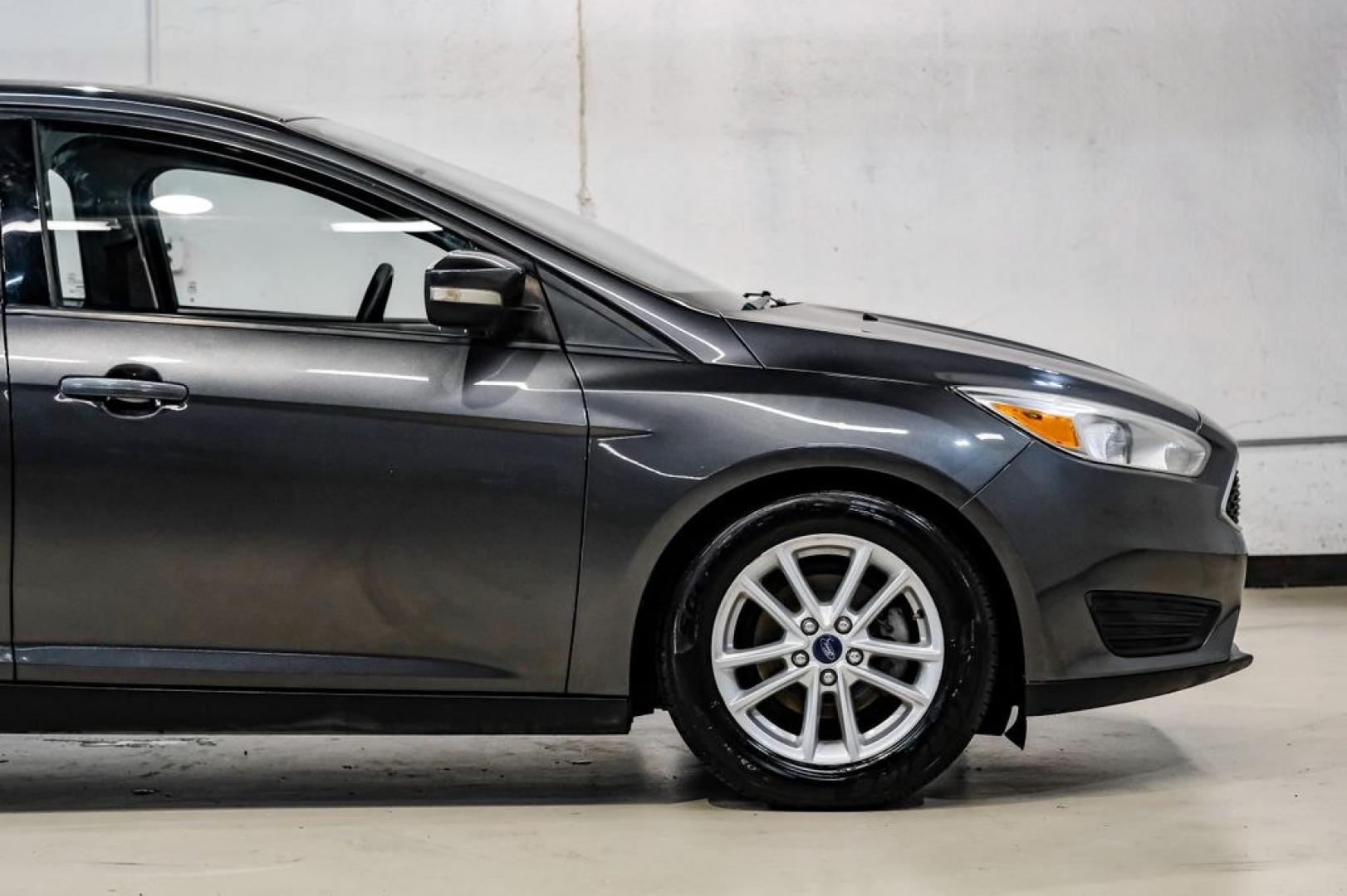 2016 Magnetic /Black Ford Focus SE (1FADP3F22GL) with an 2.0L 4-Cylinder DGI Flex Fuel DOHC engine, Automatic transmission, located at 15300 Midway Rd., Addison, TX, 75001, (972) 702-0011, 32.958321, -96.838074- Photo#10
