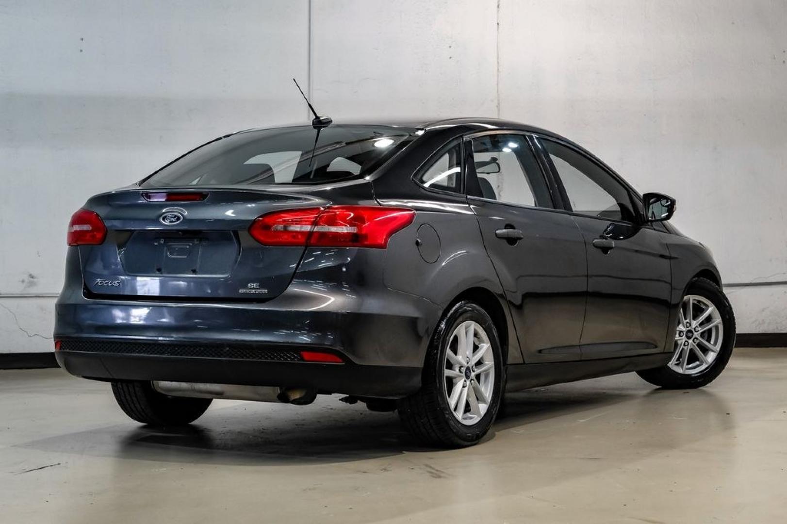 2016 Magnetic /Black Ford Focus SE (1FADP3F22GL) with an 2.0L 4-Cylinder DGI Flex Fuel DOHC engine, Automatic transmission, located at 15300 Midway Rd., Addison, TX, 75001, (972) 702-0011, 32.958321, -96.838074- Photo#11